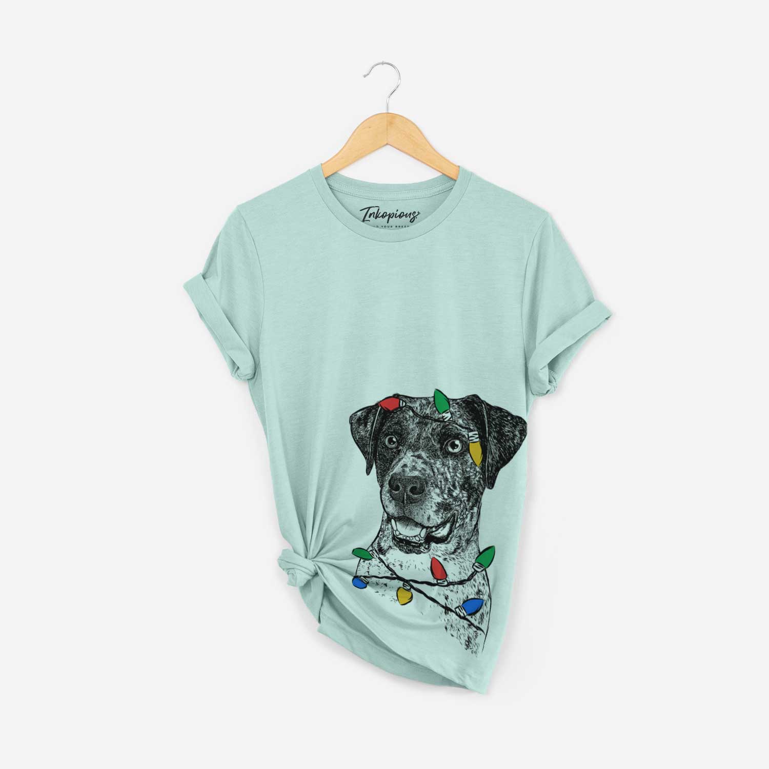 Hand-drawn sketch of Argos the Catahoula wrapped in Christmas lights on a Heather Sage Unisex crewneck