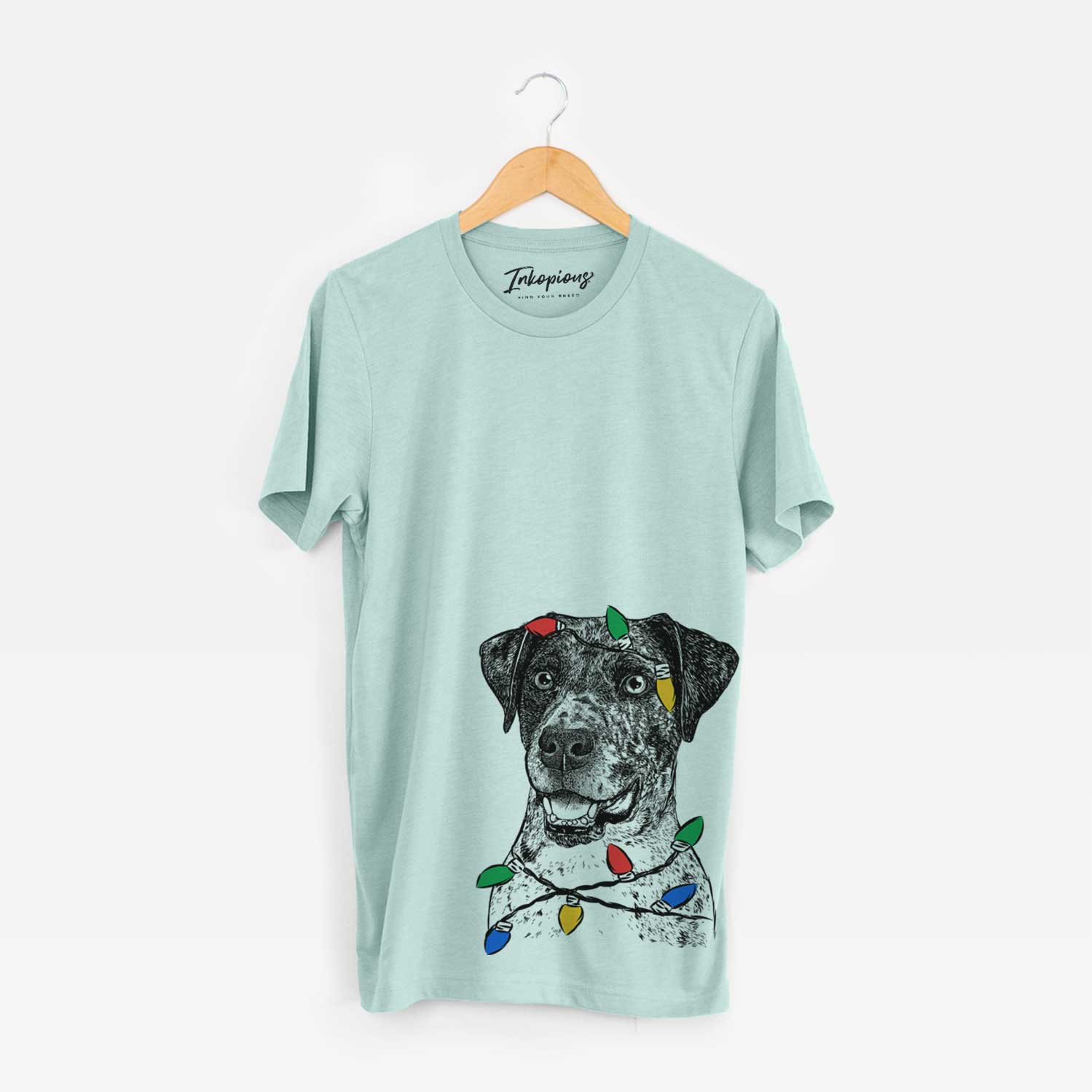 Hand-drawn sketch of Argos the Catahoula wrapped in Christmas lights on a Heather Sage Unisex crewneck