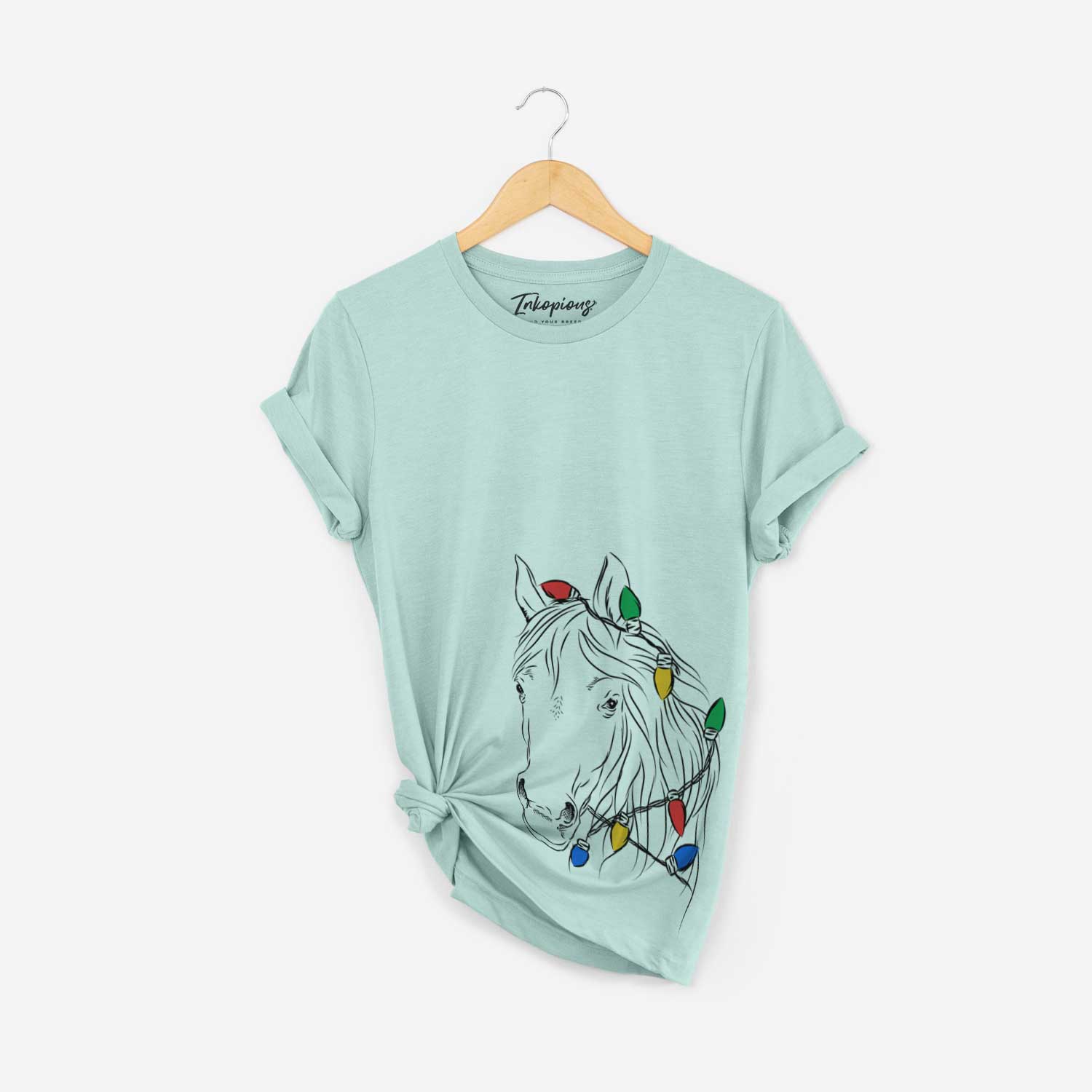 Hand-drawn sketch of Aria the Horse wrapped in Christmas lights on a Heather Sage Unisex crewneck