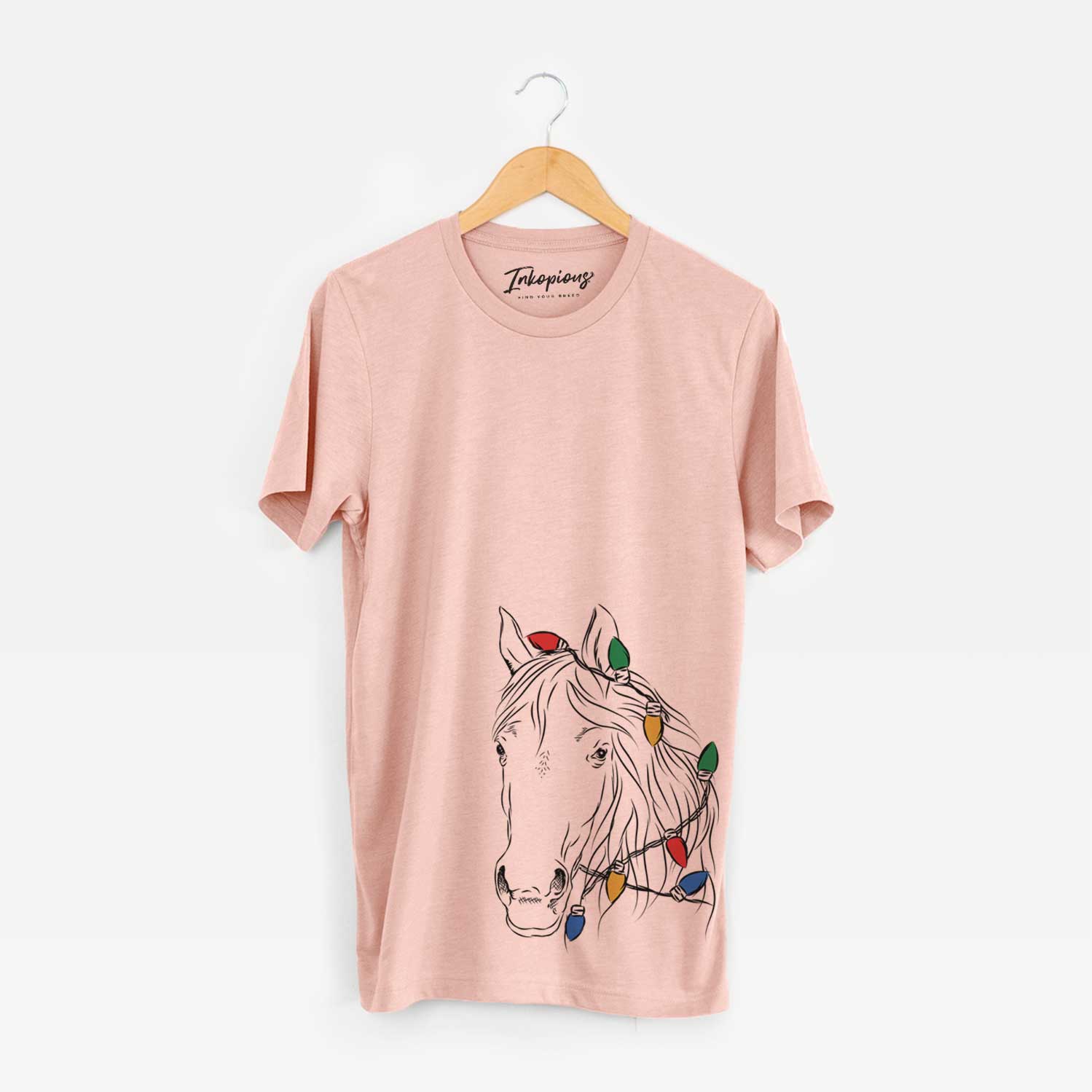 Hand-drawn sketch of Aria the Horse wrapped in Christmas lights on a Peach Unisex crewneck