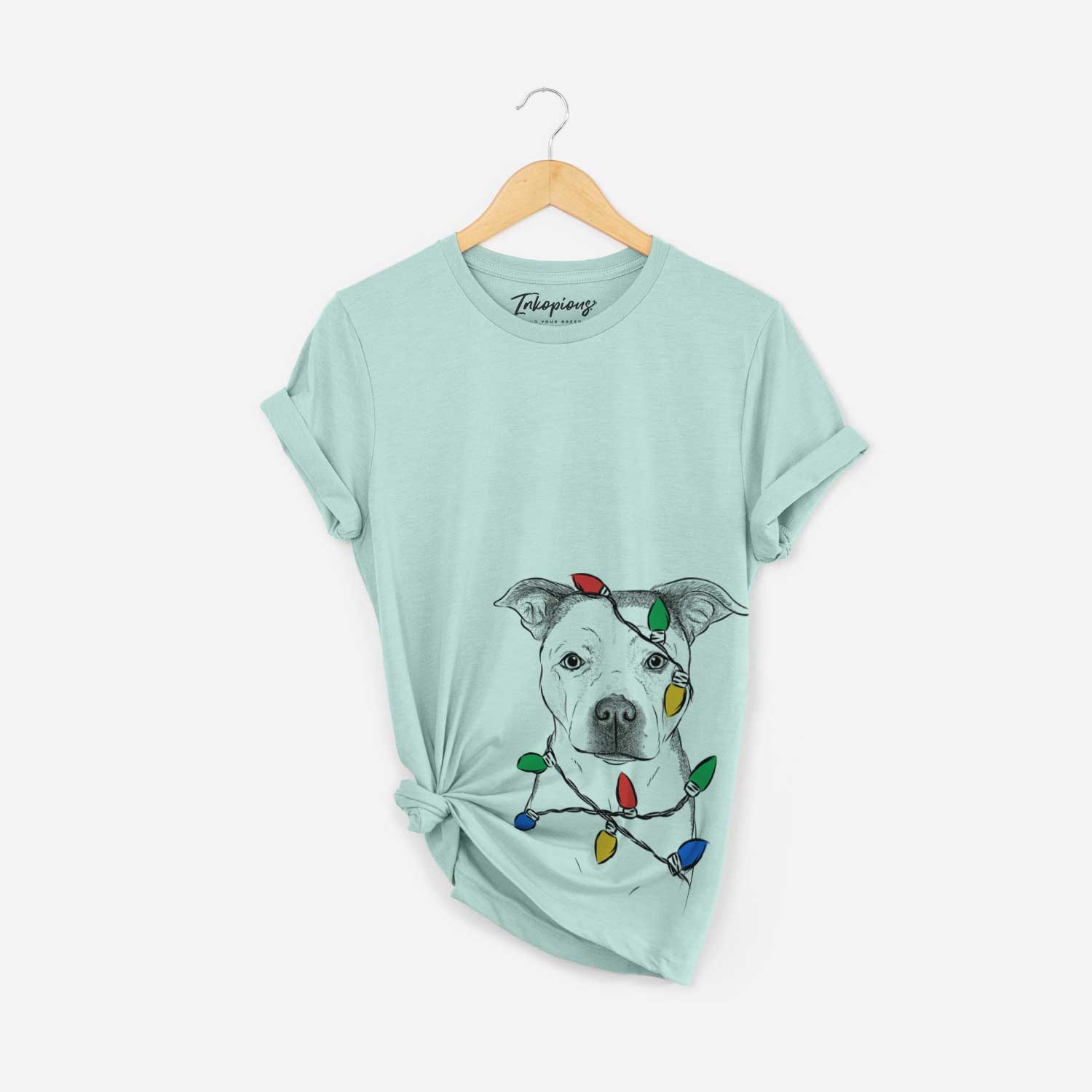 Hand-drawn sketch of Bailey the Pitbull wrapped in Christmas lights on a Heather Sage Unisex crewneck