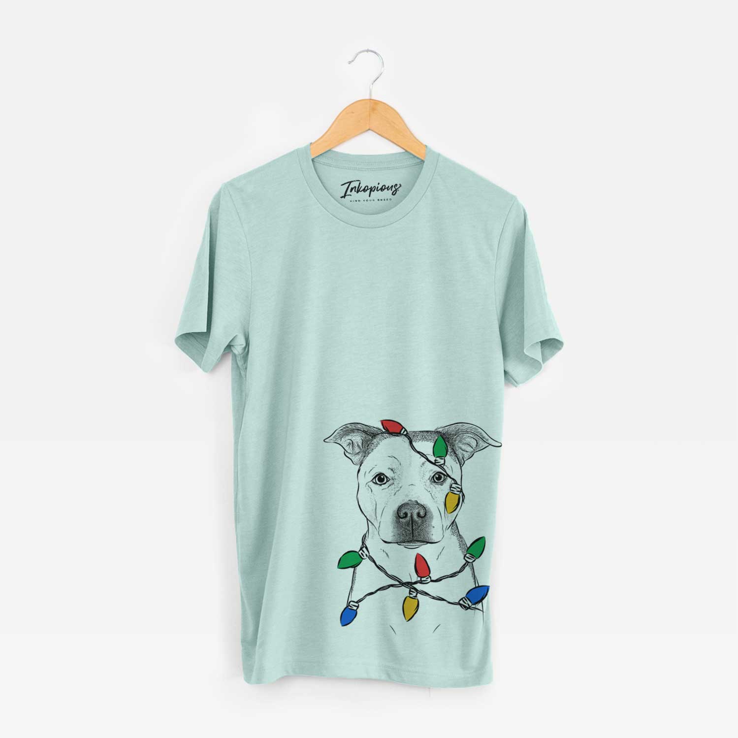 Hand-drawn sketch of Bailey the Pitbull wrapped in Christmas lights on a Heather Sage Unisex crewneck