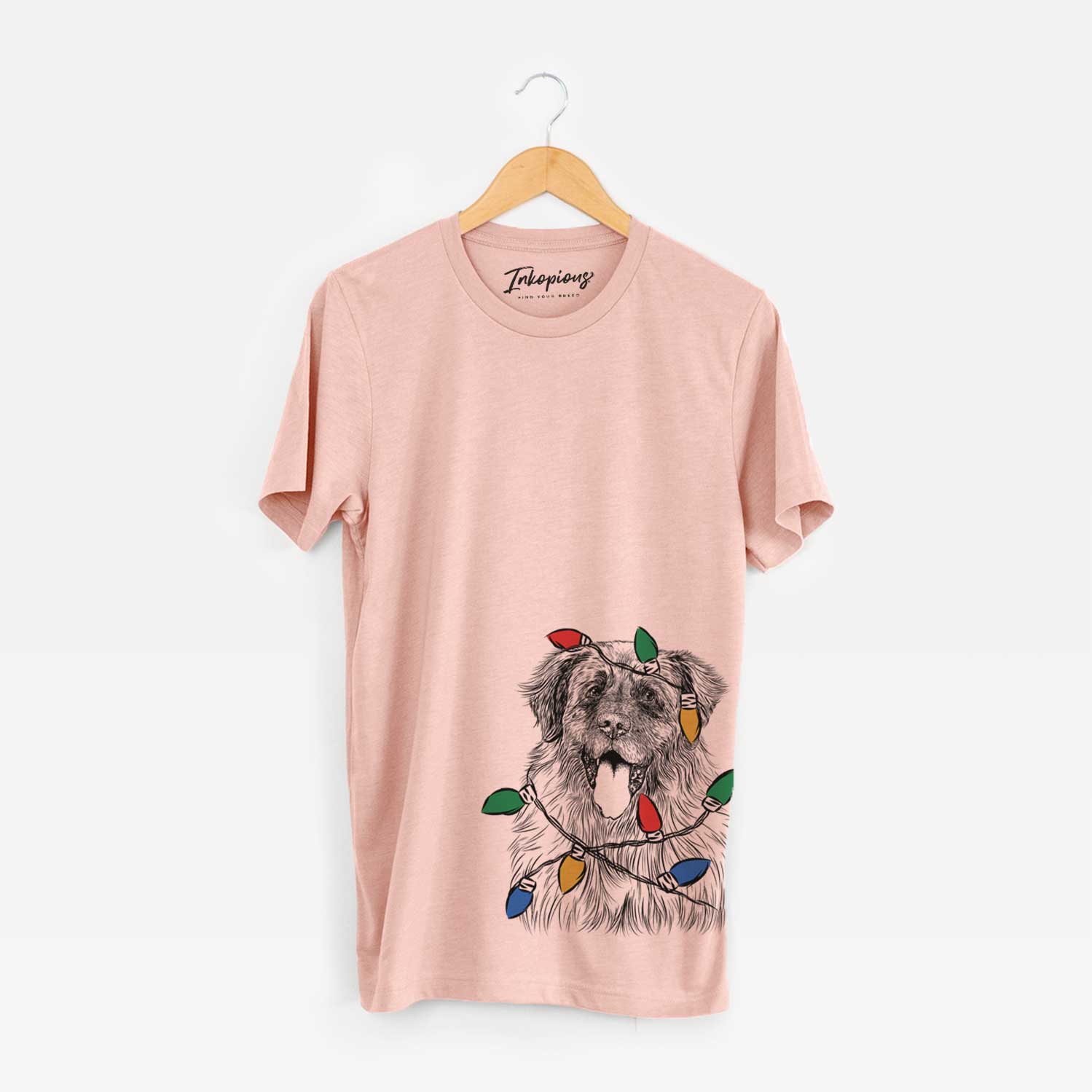 Hand-drawn sketch of Bamboo the Leonberger wrapped in Christmas lights on a Peach Unisex crewneck