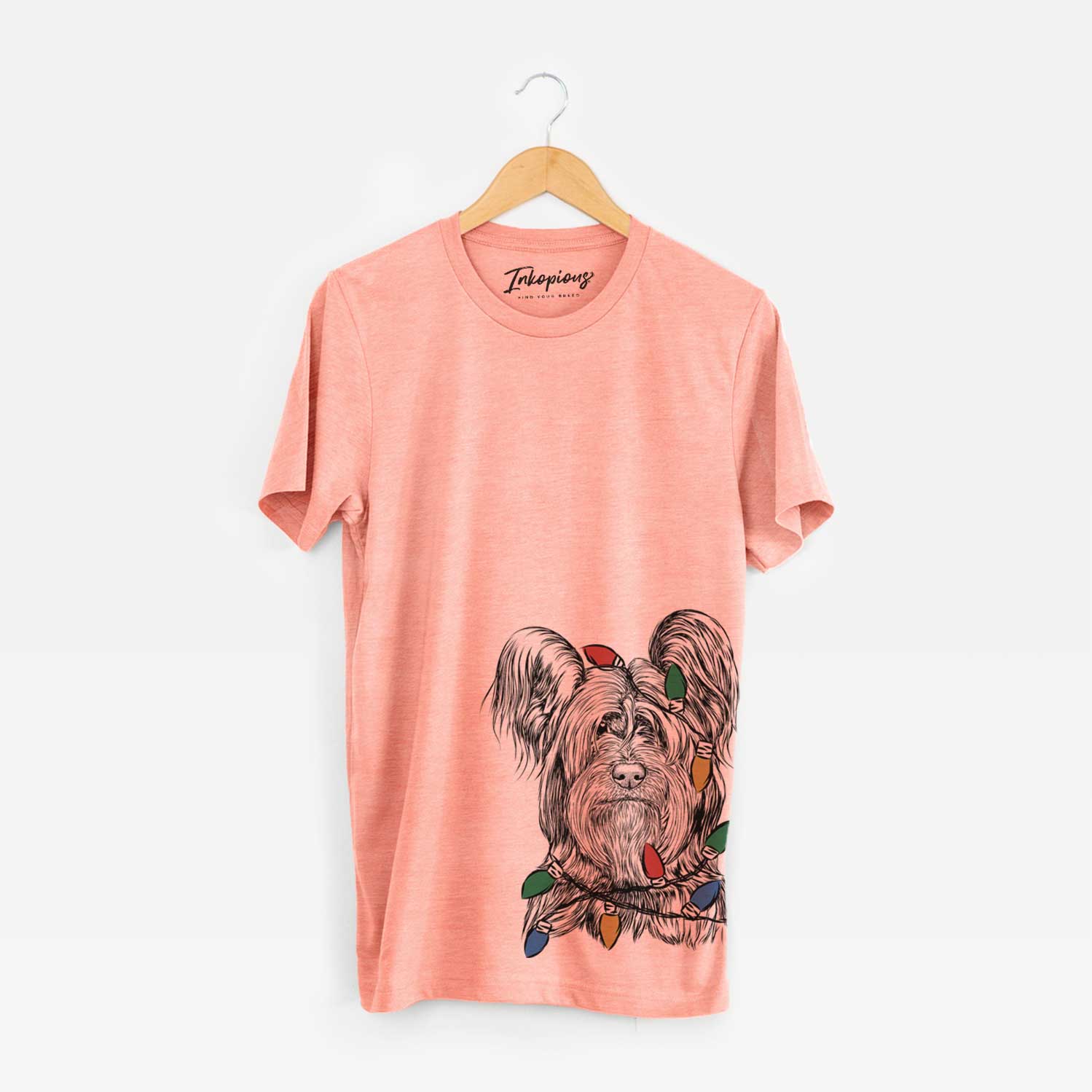 Hand-drawn sketch of Bandit the Skye Terrier wrapped in Christmas lights on a Sunset Unisex crewneck