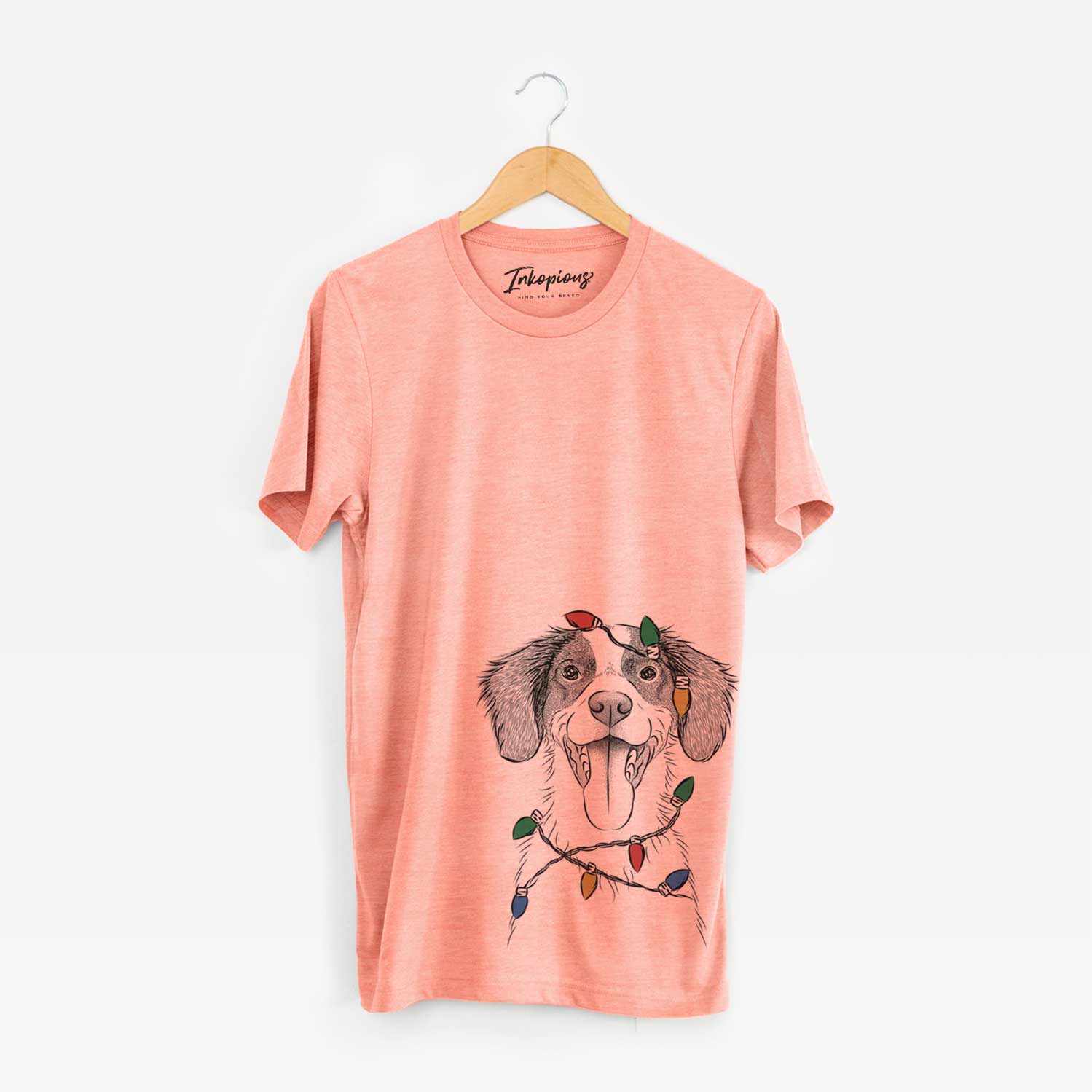 Hand-drawn sketch of Birdie the Brittany wrapped in Christmas lights on a Sunset Unisex crewneck