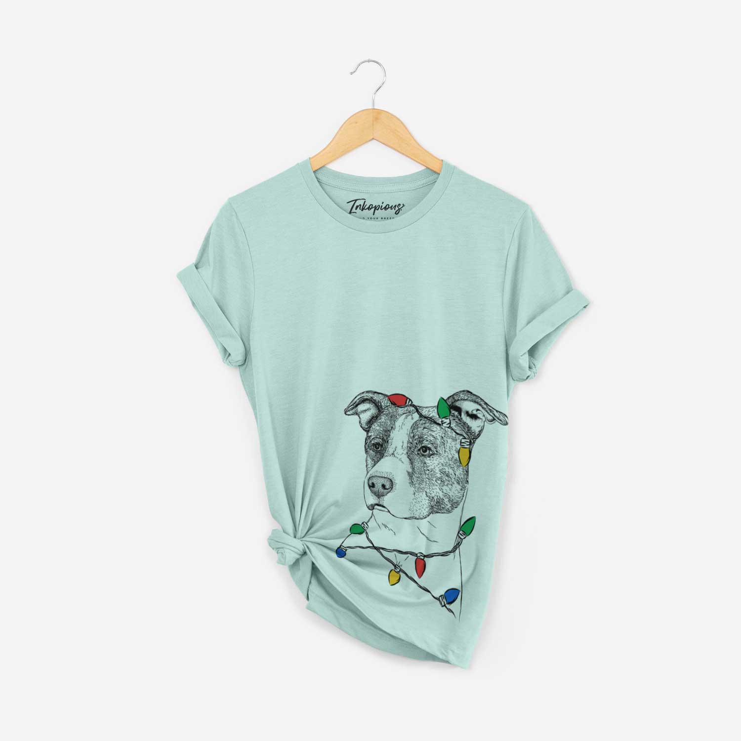 Hand-drawn sketch of Blu the Pitbull wrapped in Christmas lights on a Heather Sage Unisex crewneck
