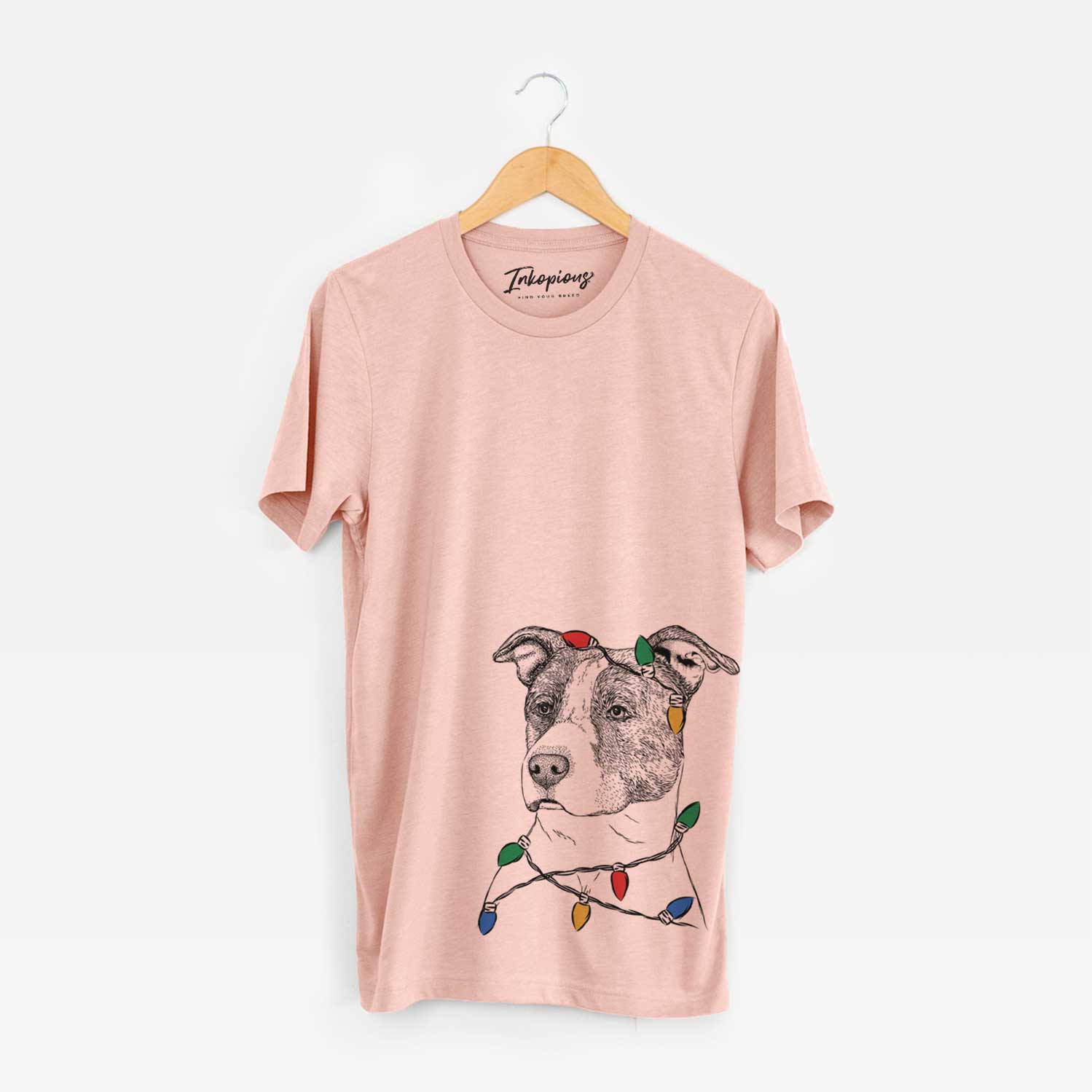 Hand-drawn sketch of Blu the Pitbull wrapped in Christmas lights on a Peach Unisex crewneck