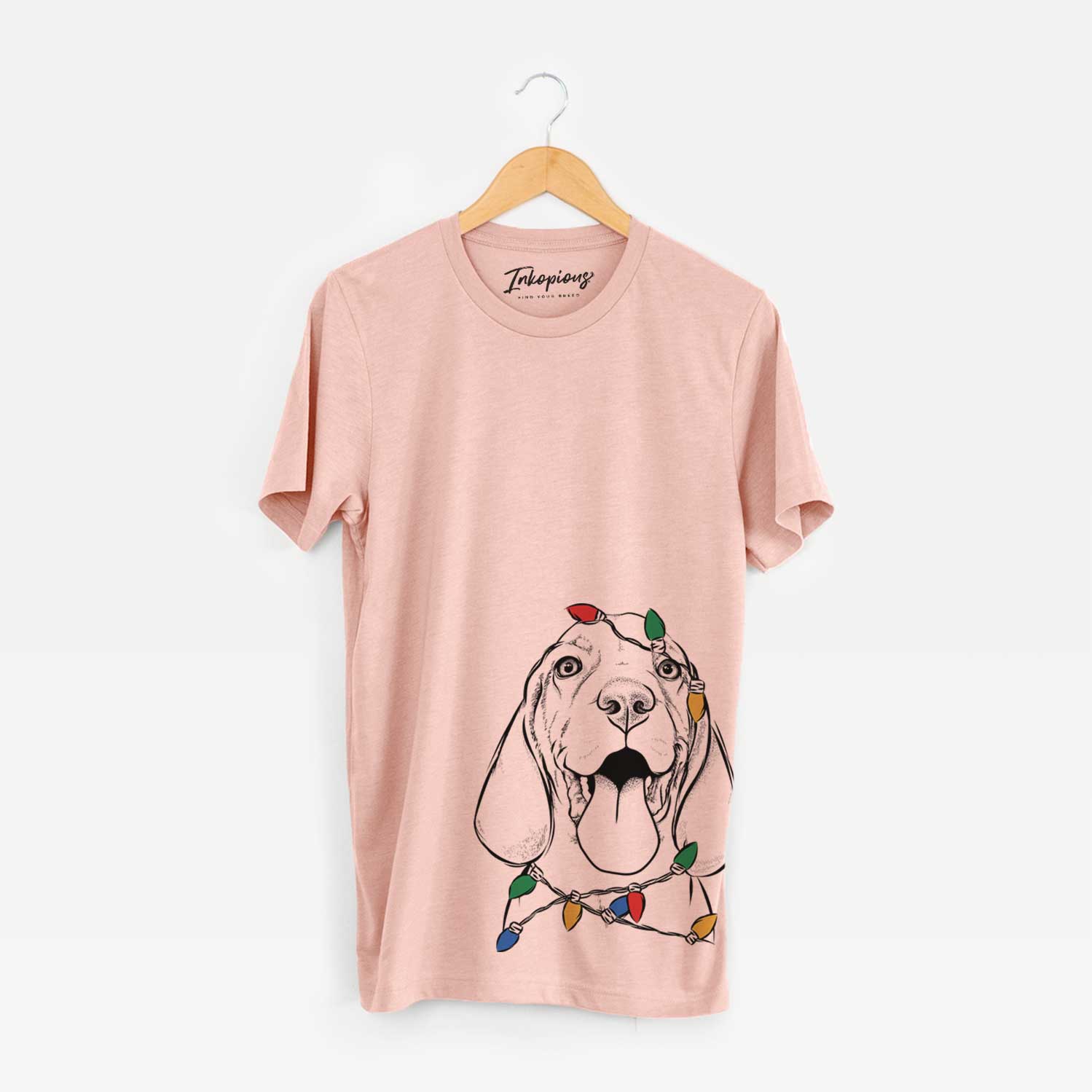 Hand-drawn sketch of Bodi the Vizsla wrapped in Christmas lights on a Peach Unisex crewneck