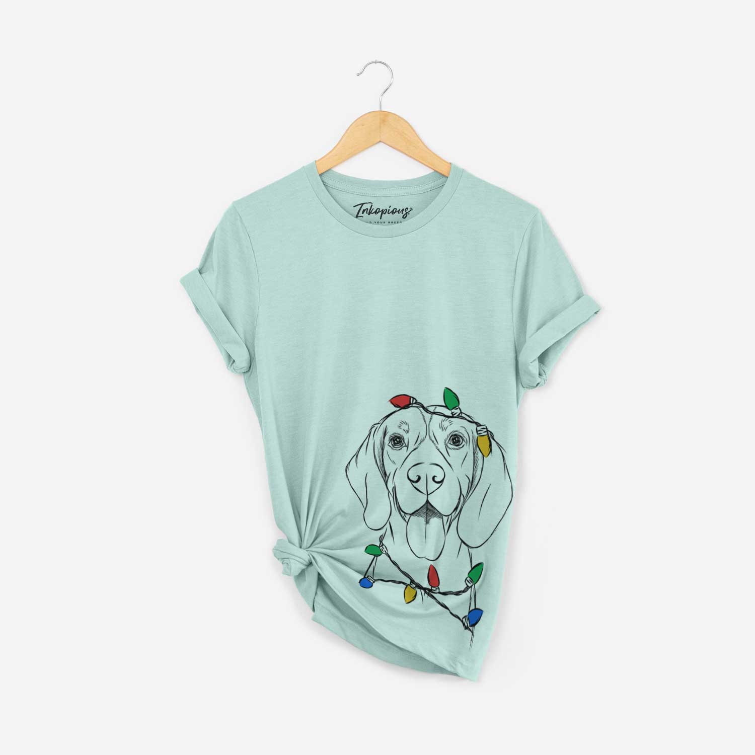 Hand-drawn sketch of Bogie the Beagle wrapped in Christmas lights on a Heather Sage Unisex crewneck