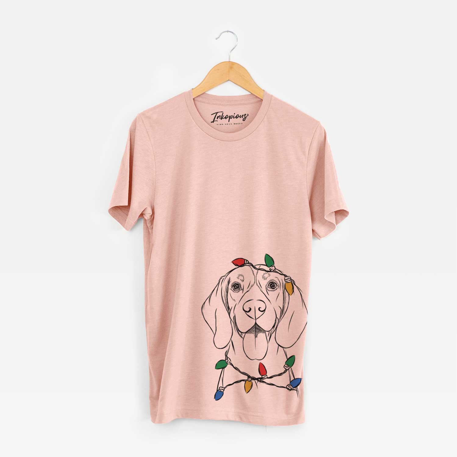 Hand-drawn sketch of Bogie the Beagle wrapped in Christmas lights on a Peach Unisex crewneck