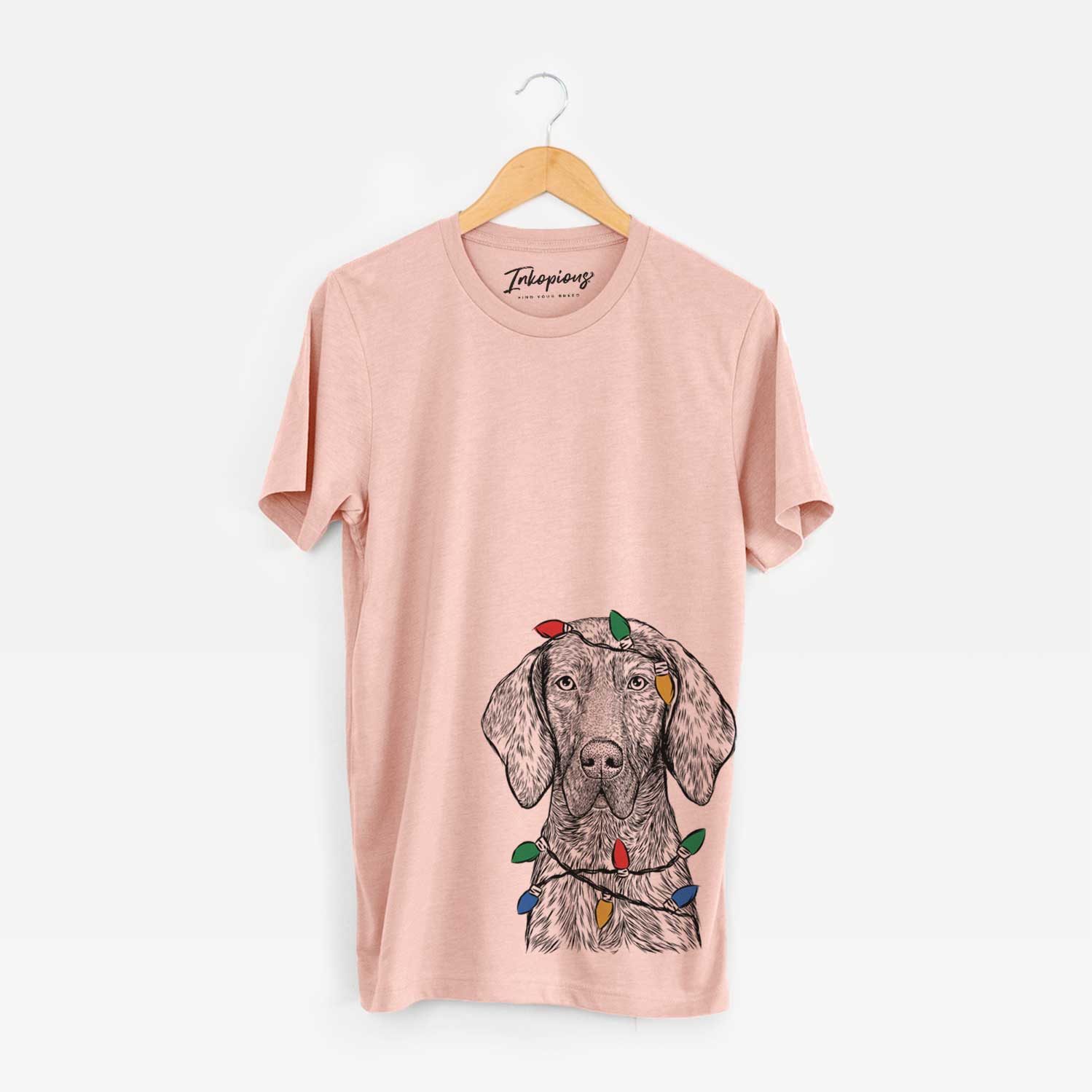 Hand-drawn sketch of Boone the Plott Hound wrapped in Christmas lights on a Peach Unisex crewneck