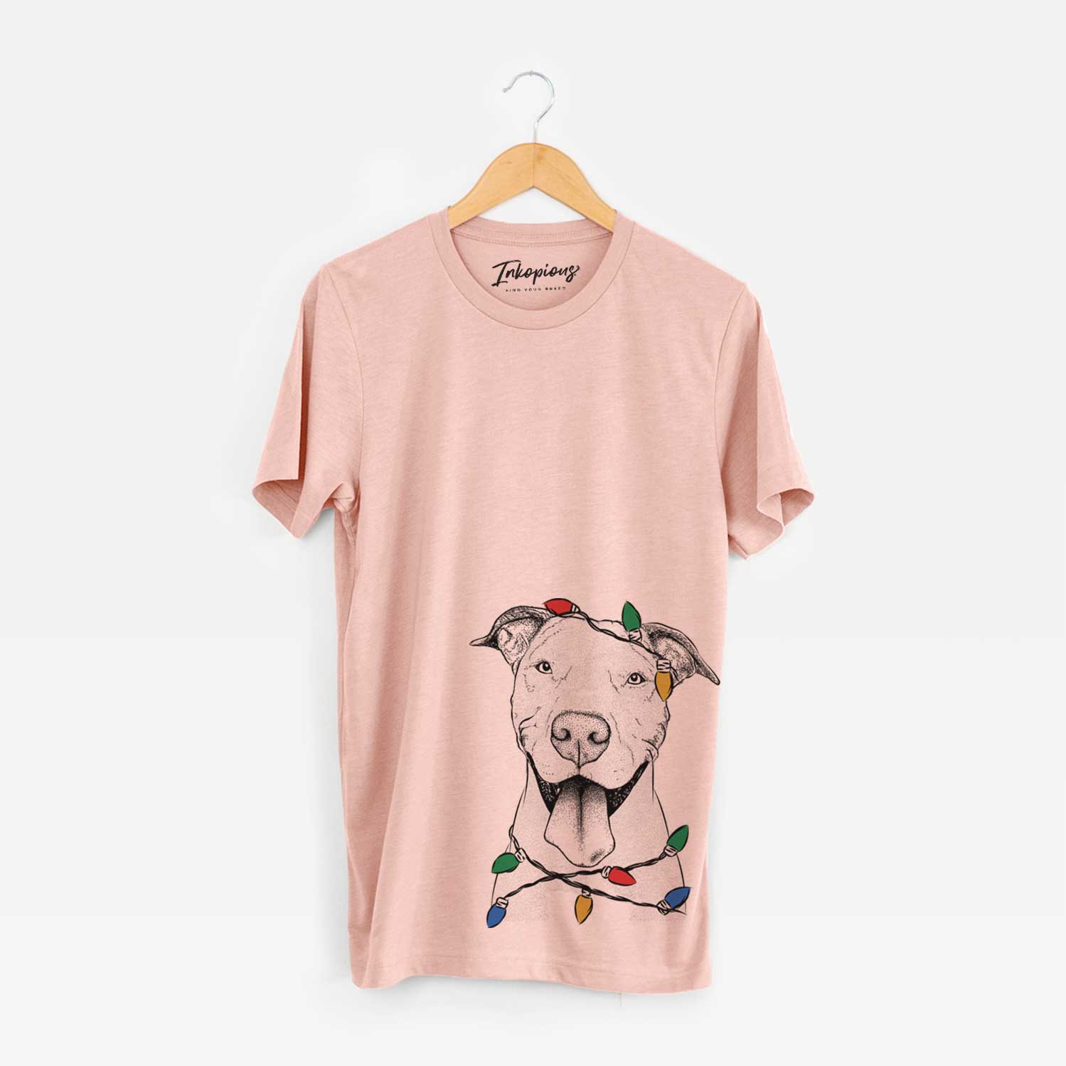 Hand-drawn sketch of Bruce the American Staffordshire Terrier wrapped in Christmas lights on a Peach Unisex crewneck