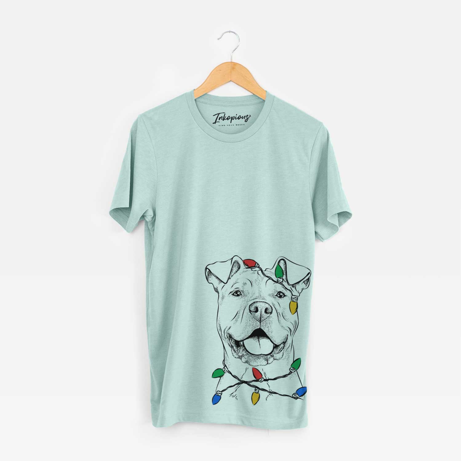 Hand-drawn sketch of Bubba Scraps the American Staffordshire Mix wrapped in Christmas lights on a Heather Sage Unisex crewneck