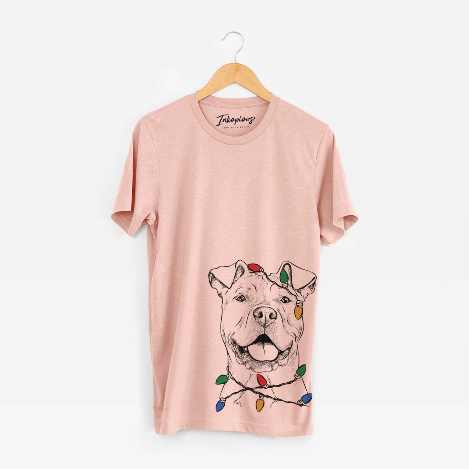 Hand-drawn sketch of Bubba Scraps the American Staffordshire Mix wrapped in Christmas lights on a Peach Unisex crewneck