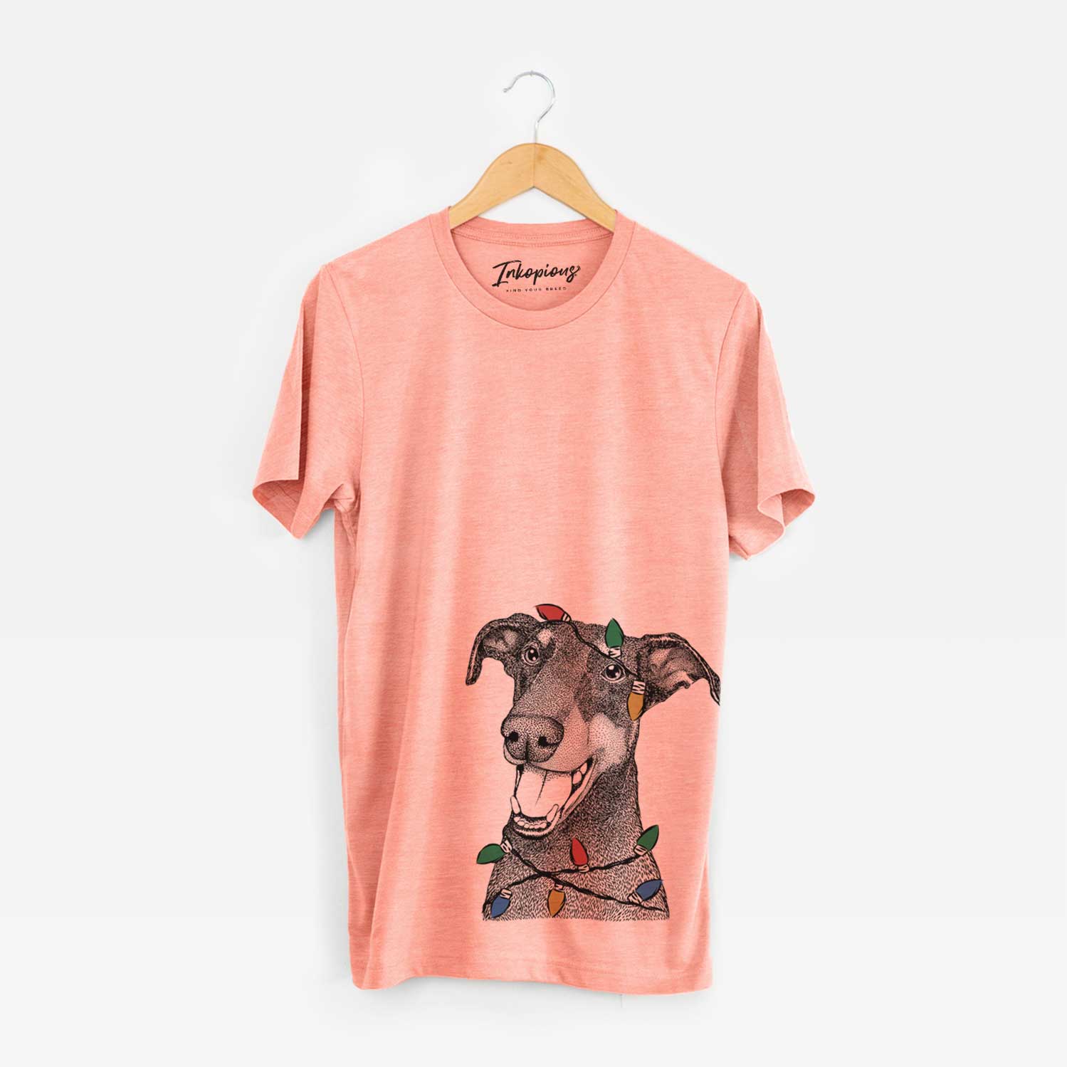 Hand-drawn sketch of Bunnie the Doberman Pinscher wrapped in Christmas lights on a Sunset Unisex crewneck