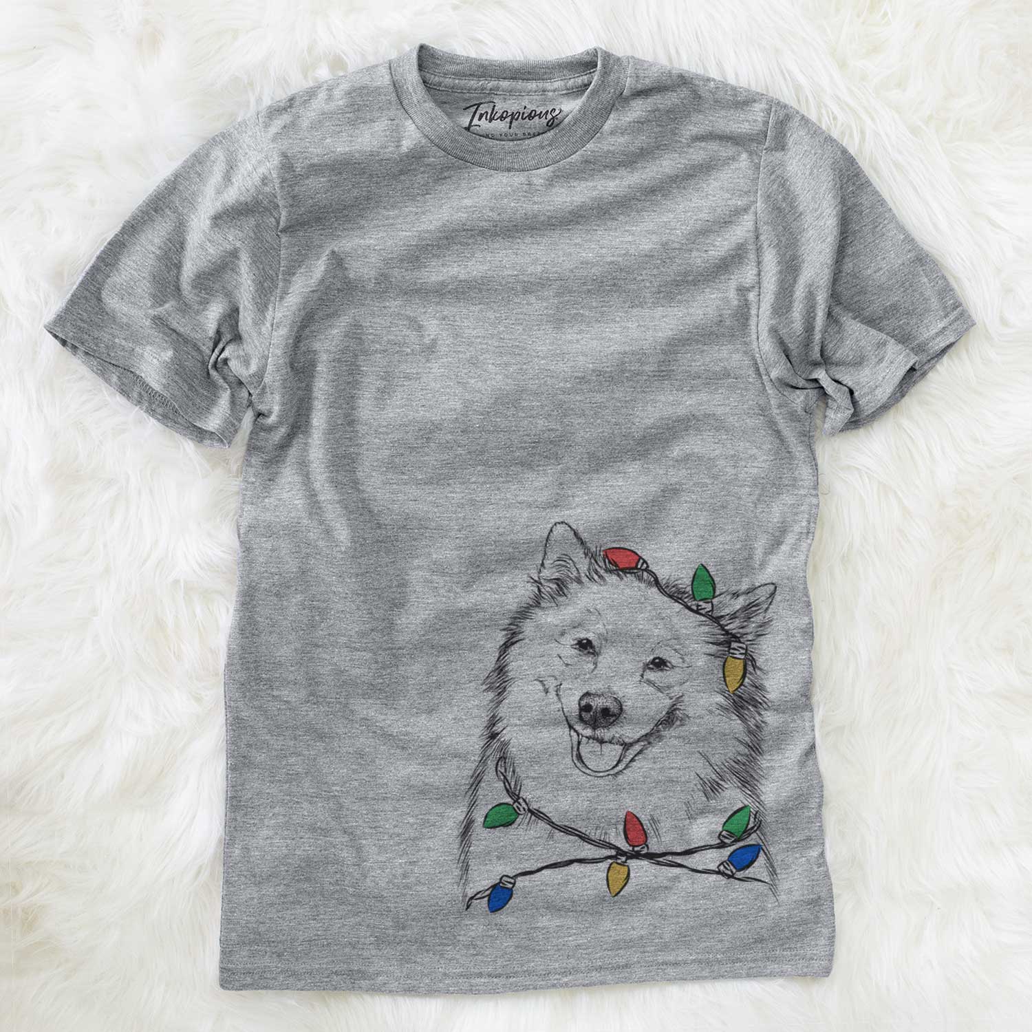 Hand-drawn sketch of Caico the Samoyed wrapped in Christmas lights on a Grey Unisex crewneck