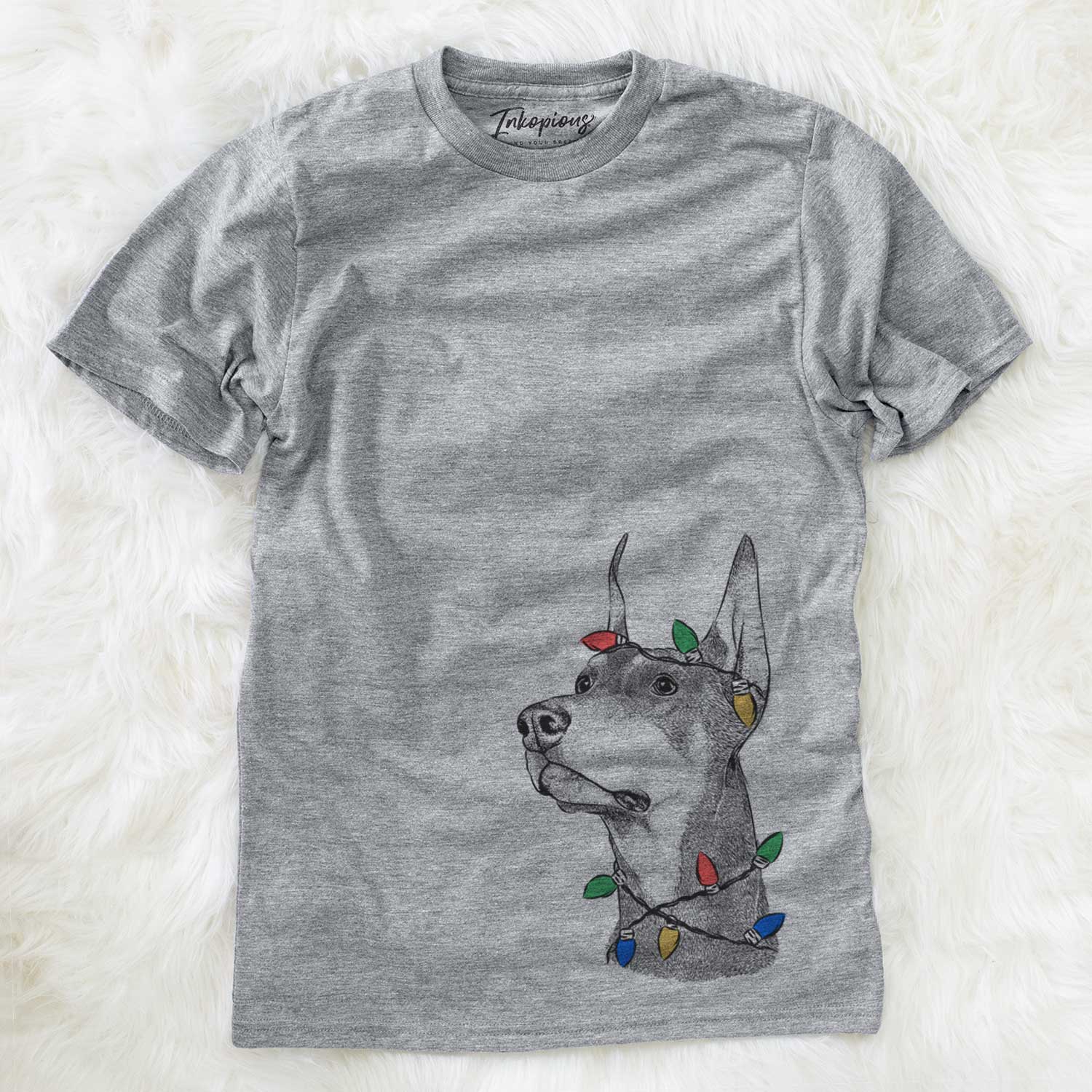 Hand-drawn sketch of Cenza the Doberman Pinscher wrapped in Christmas lights on a Grey Unisex crewneck