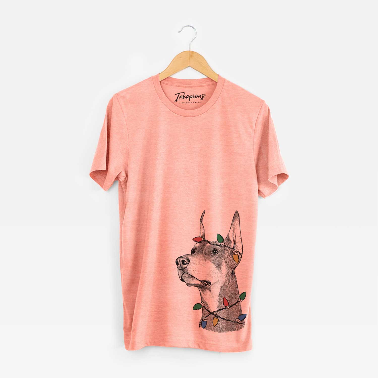 Hand-drawn sketch of Cenza the Doberman Pinscher wrapped in Christmas lights on a Sunset Unisex crewneck