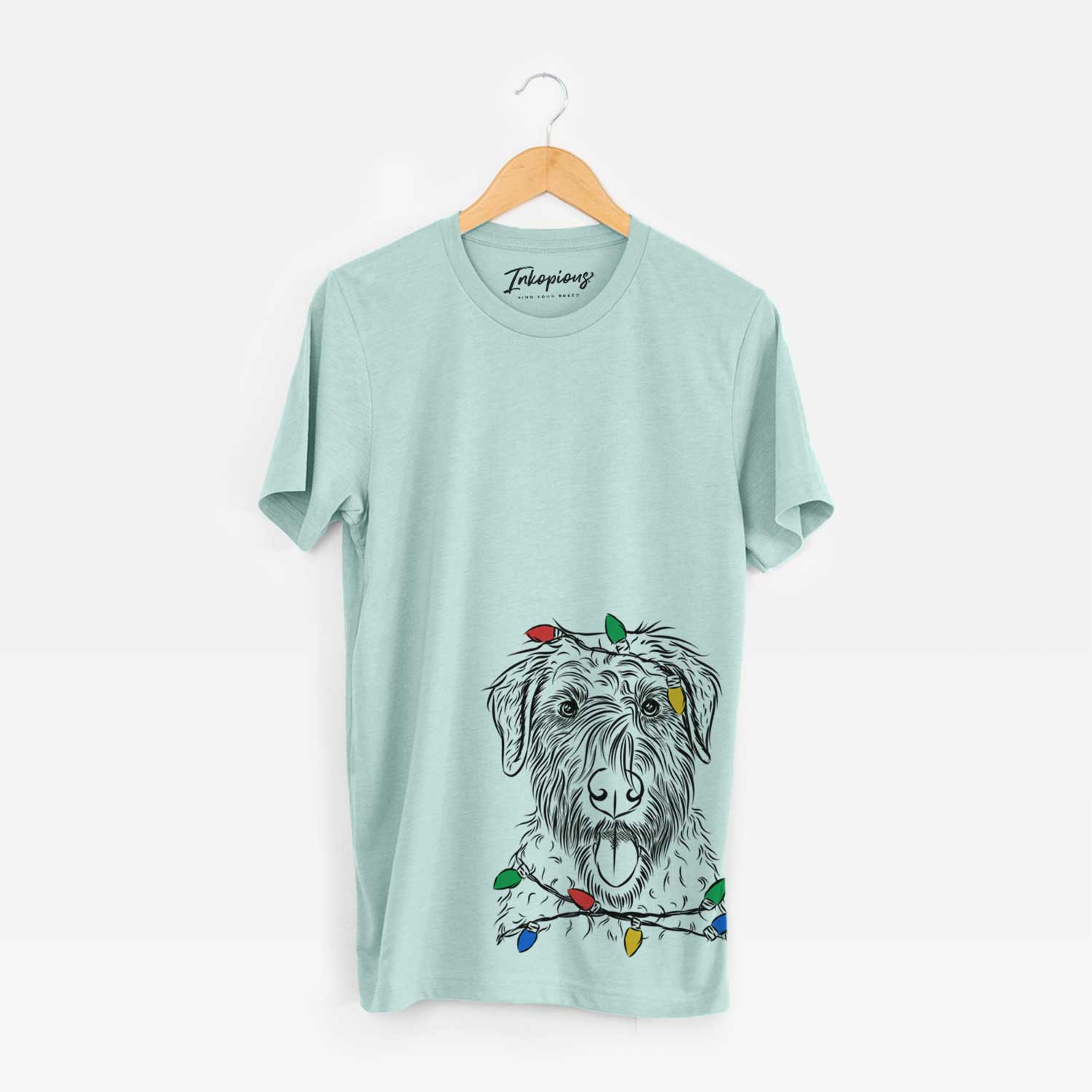 Hand-drawn sketch of Chester the Soft Coated Wheaten Terrier wrapped in Christmas lights on a Heather Sage Unisex crewneck