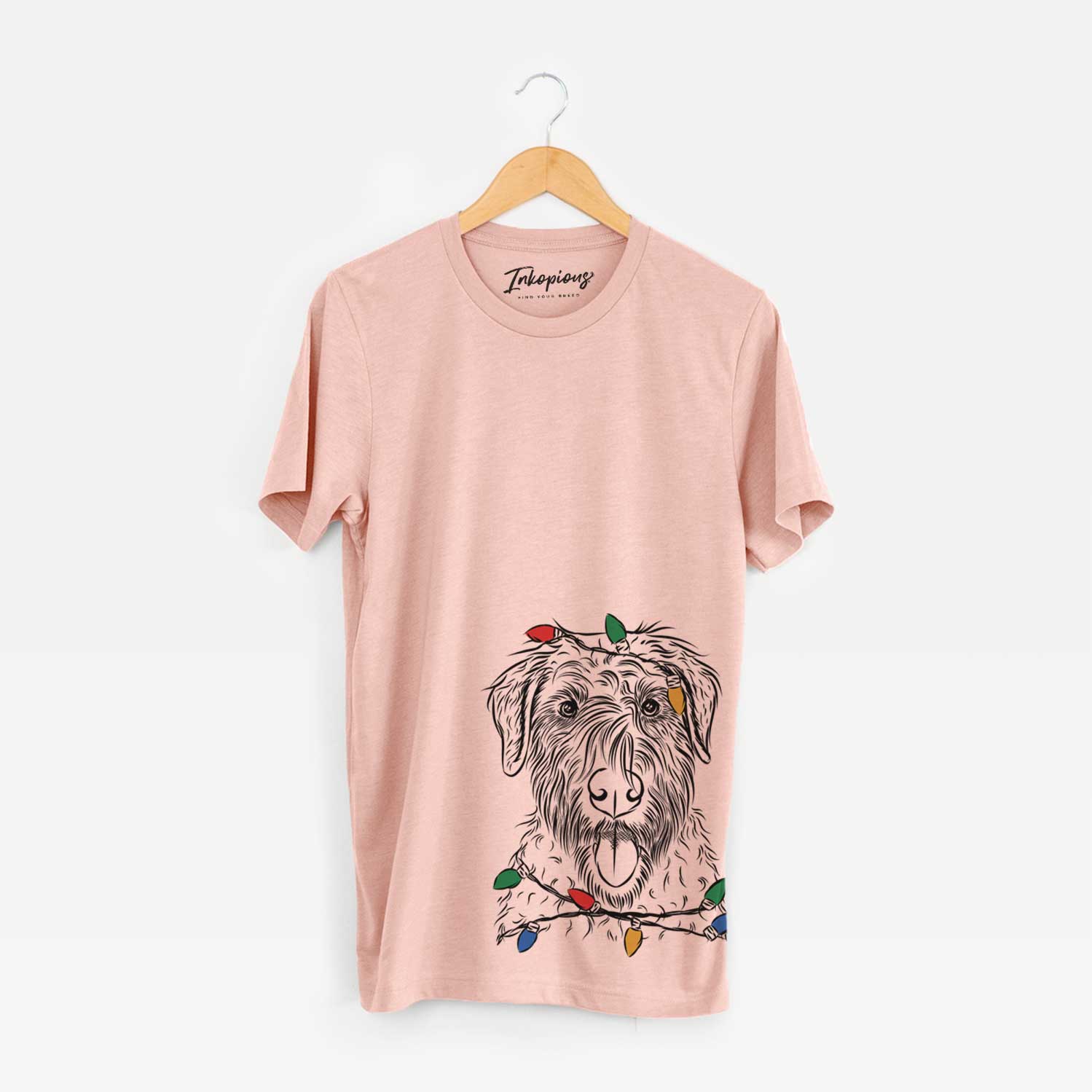 Hand-drawn sketch of Chester the Soft Coated Wheaten Terrier wrapped in Christmas lights on a Peach Unisex crewneck