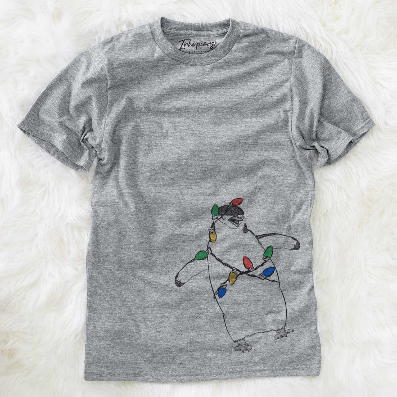 Hand-drawn sketch of Chive the Chinstrap Penguin wrapped in Christmas lights on a Grey Unisex crewneck