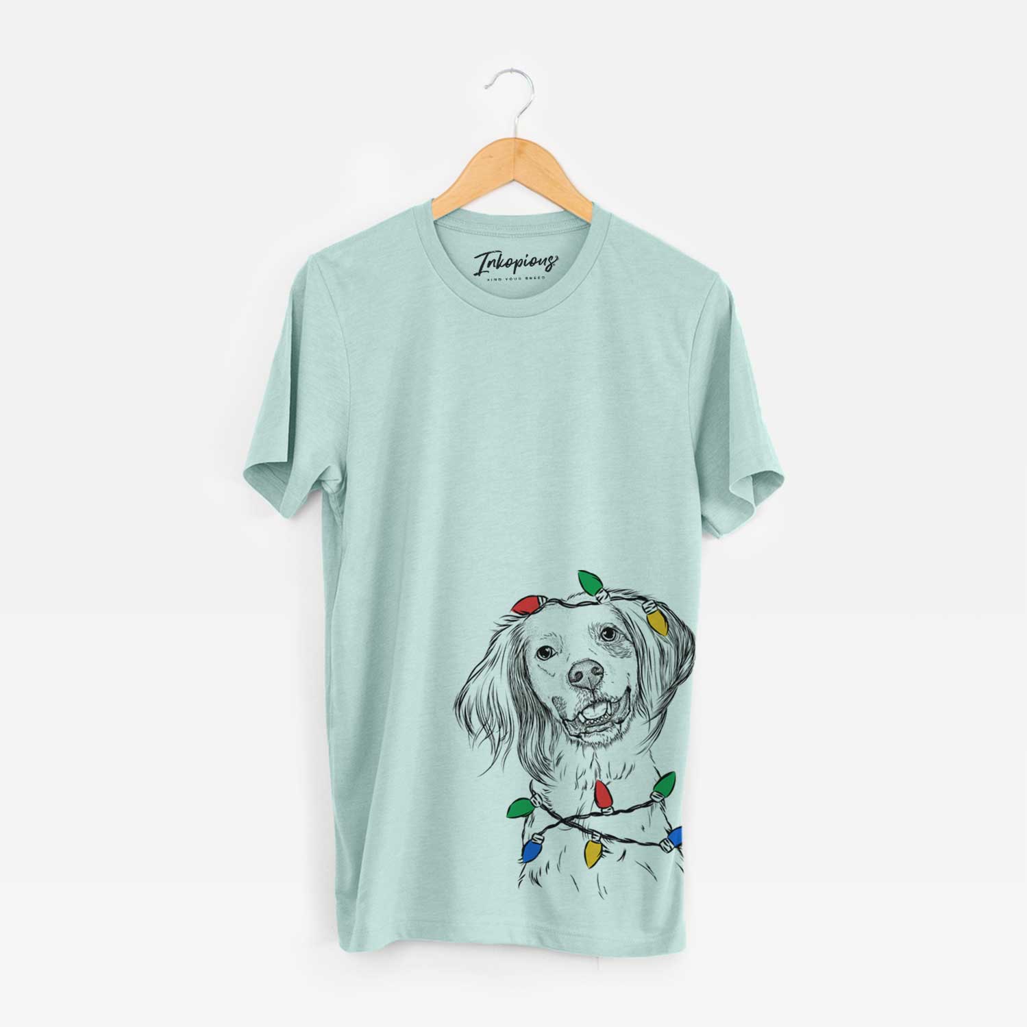 Hand-drawn sketch of Cooper the English Setter wrapped in Christmas lights on a Heather Sage Unisex crewneck