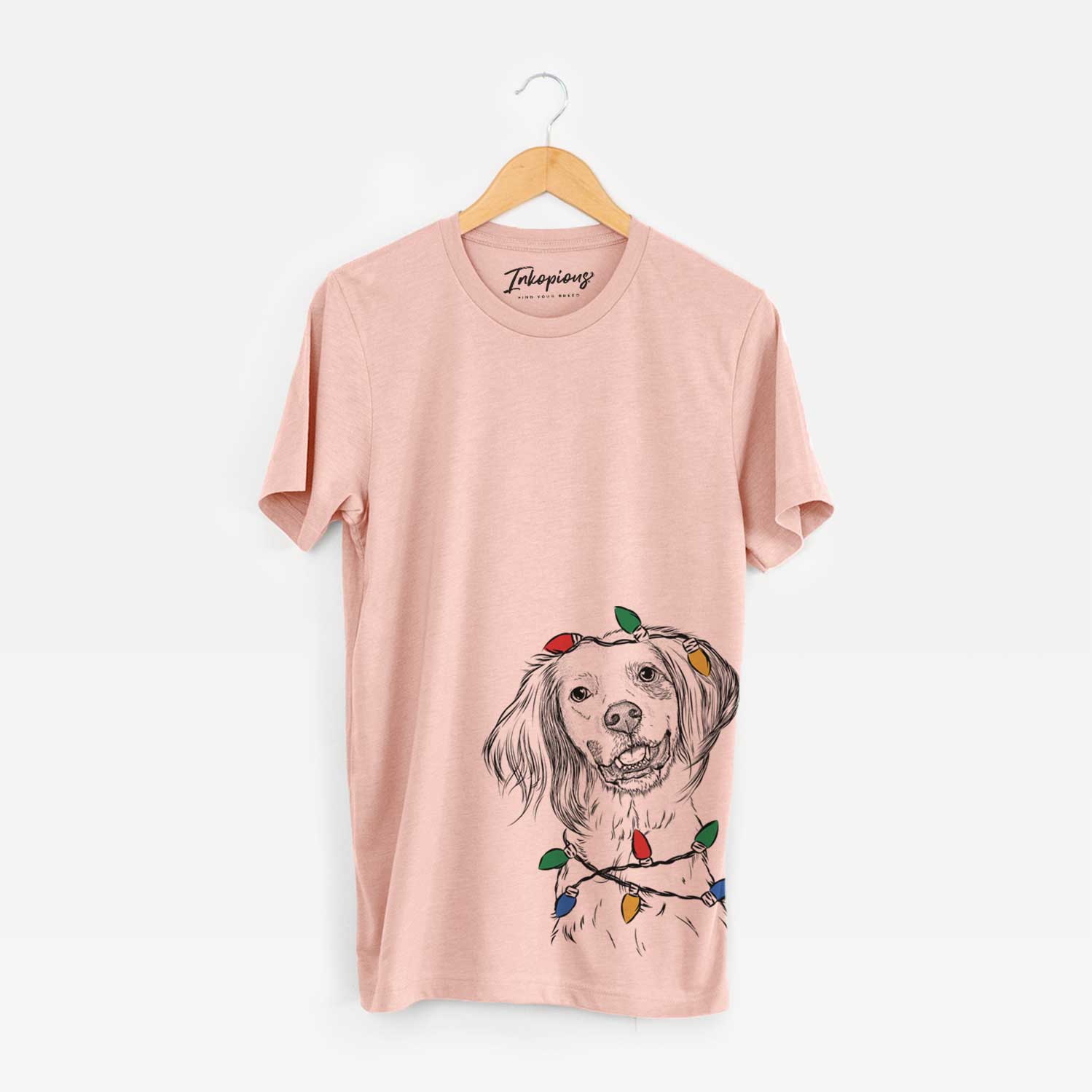Hand-drawn sketch of Cooper the English Setter wrapped in Christmas lights on a Peach Unisex crewneck