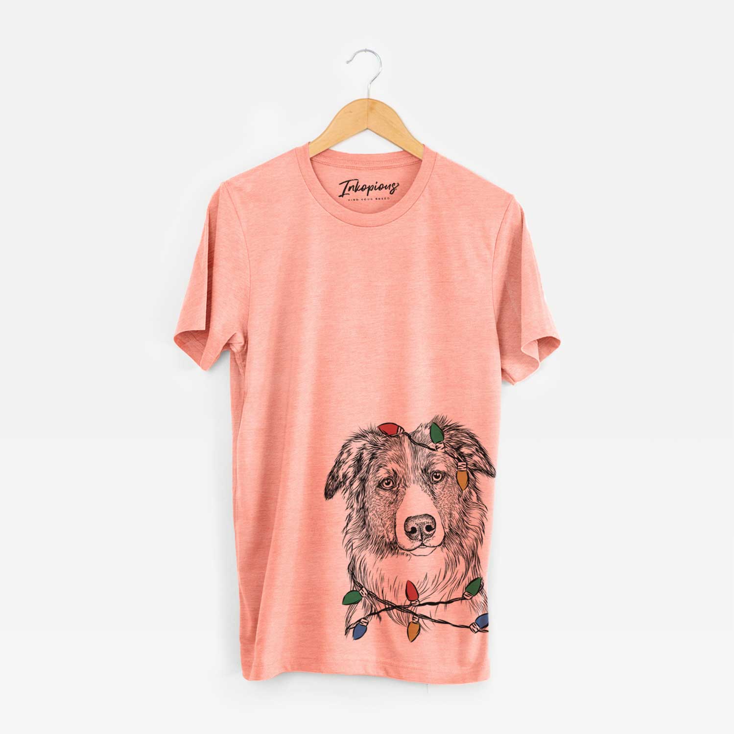 Hand-drawn sketch of Cynder the English Shepherd wrapped in Christmas lights on a Sunset Unisex crewneck