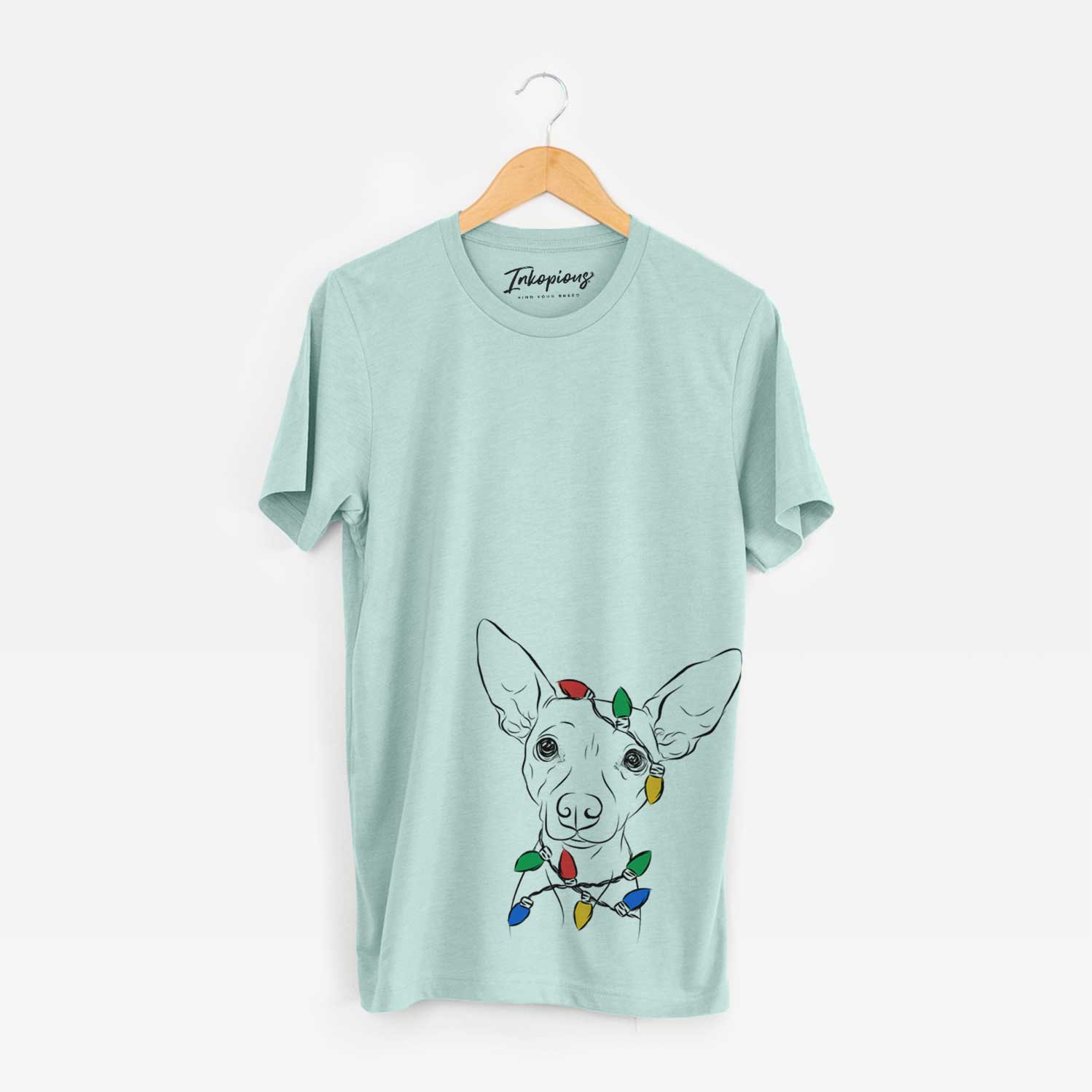 Hand-drawn sketch of Desi the American Hairless Terrier wrapped in Christmas lights on a Heather Sage Unisex crewneck