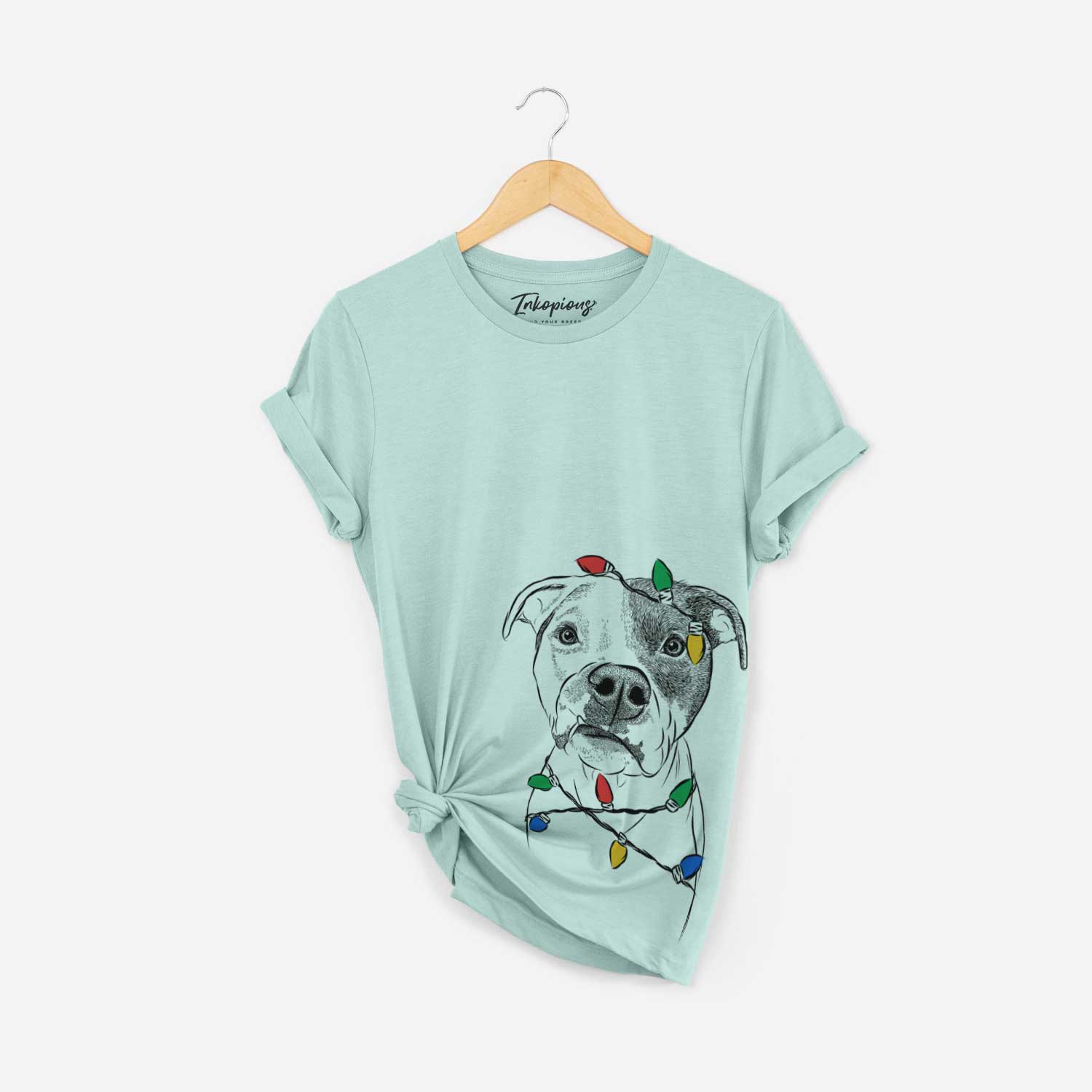 Hand-drawn sketch of Dexter the Pitbull wrapped in Christmas lights on a Heather Sage Unisex crewneck