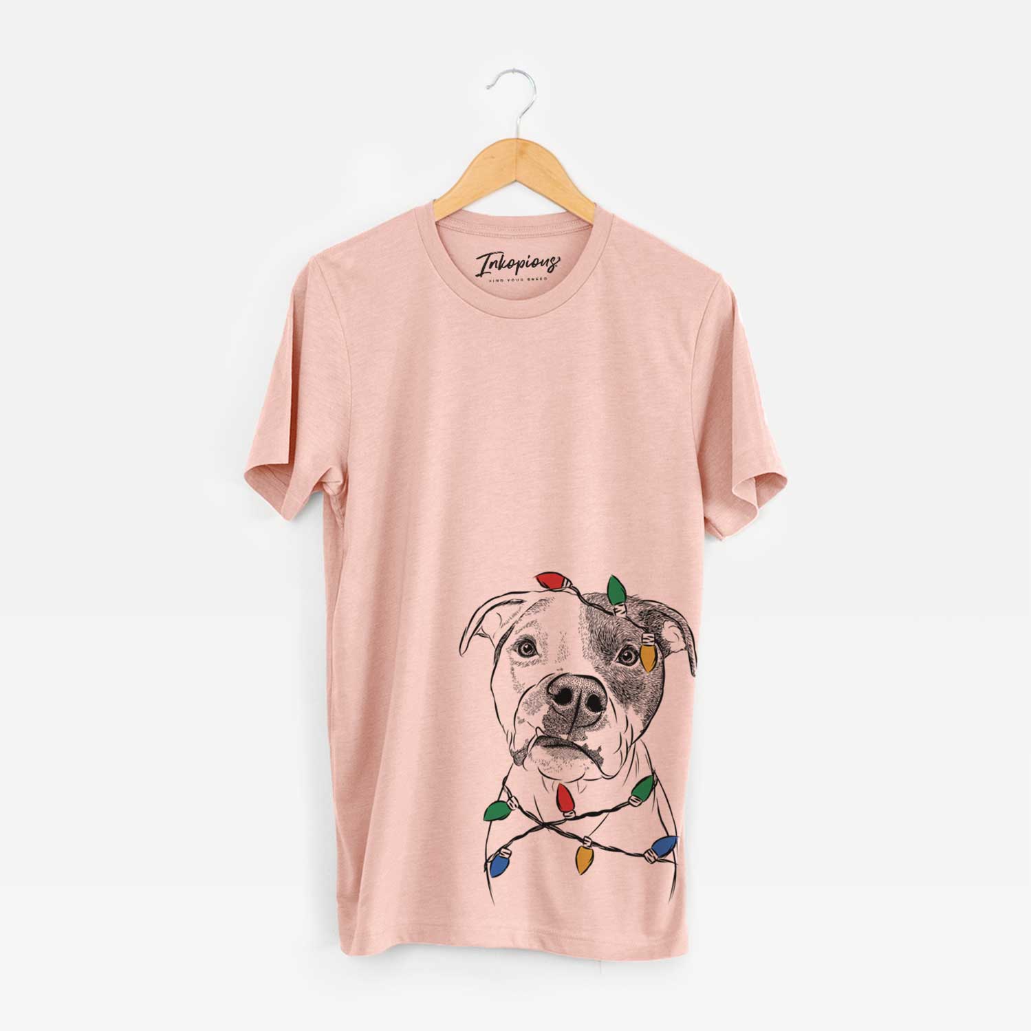 Hand-drawn sketch of Dexter the Pitbull wrapped in Christmas lights on a Peach Unisex crewneck