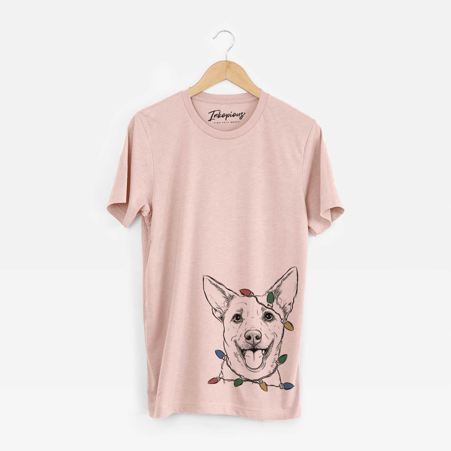 Hand-drawn sketch of Dinghy the Mixed Breed wrapped in Christmas lights on a Peach Unisex crewneck