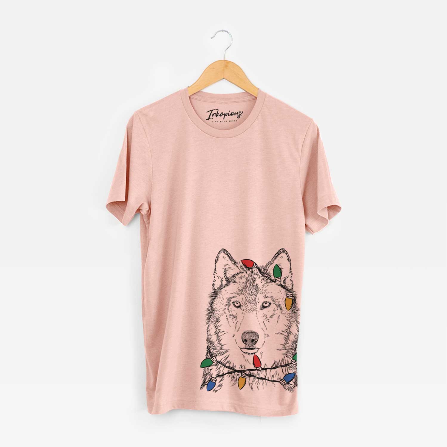 Hand-drawn sketch of Django the Grey Wolf wrapped in Christmas lights on a Peach Unisex crewneck