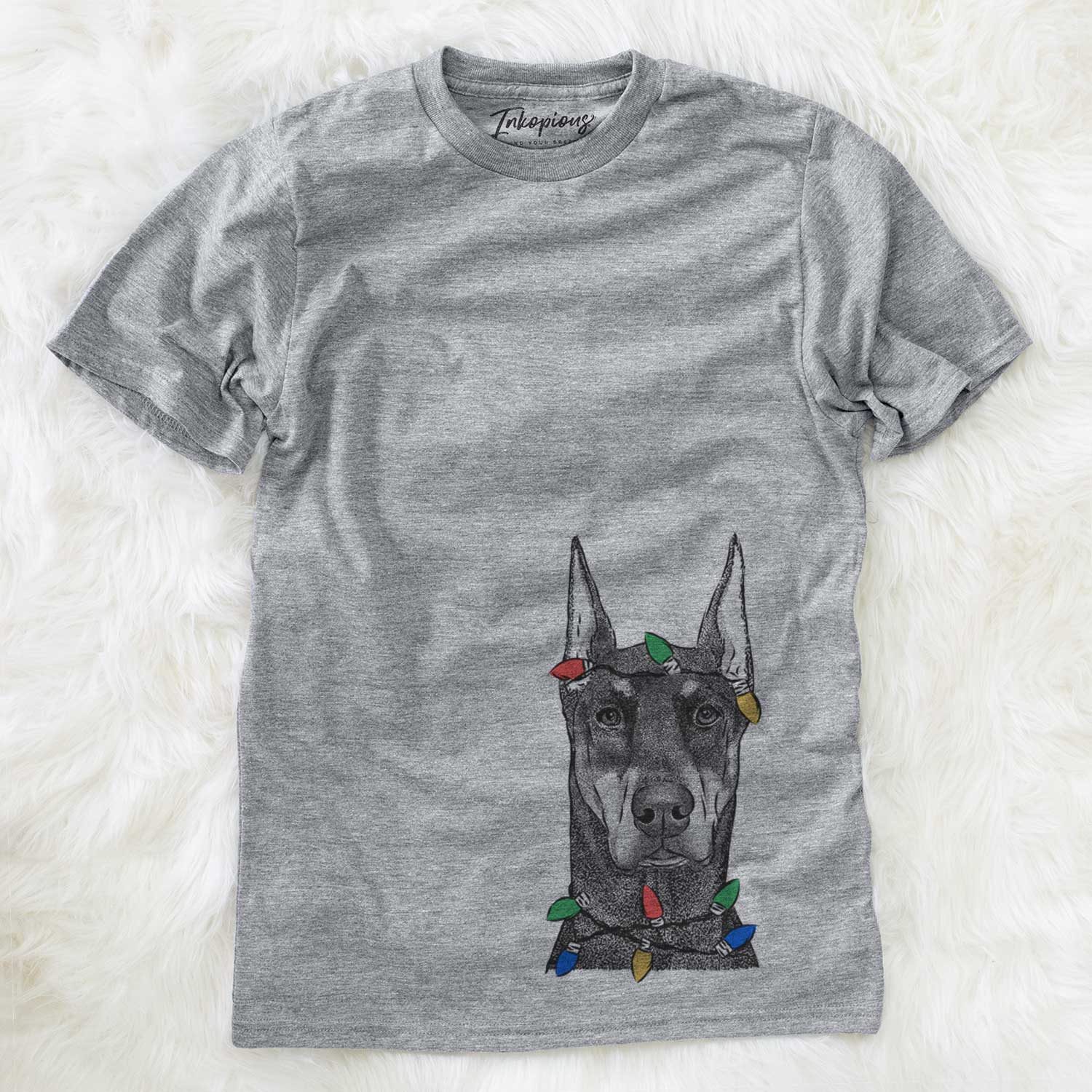 Hand-drawn sketch of Drake the Doberman Pinscher wrapped in Christmas lights on a Grey Unisex crewneck