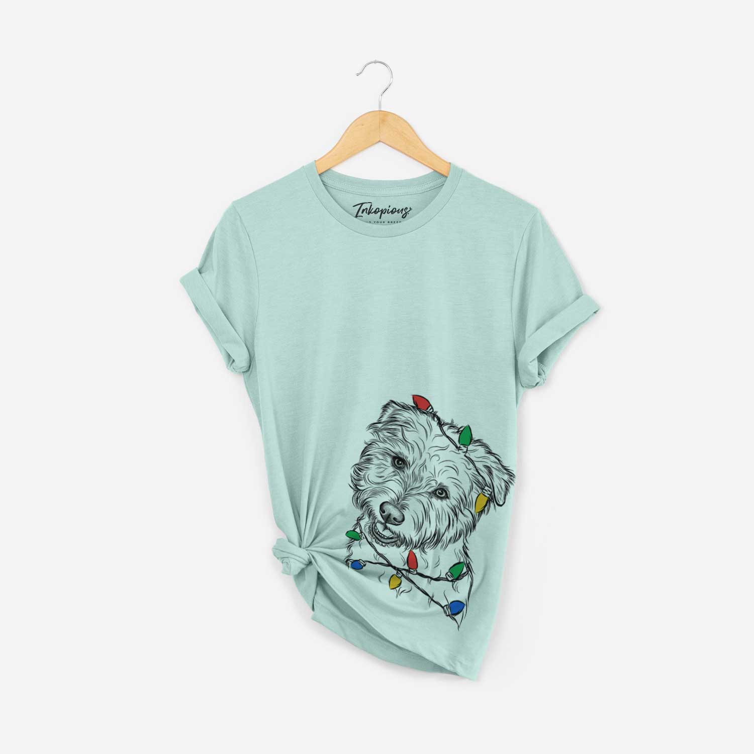 Hand-drawn sketch of Duffy the Glen of Imaal Terrier wrapped in Christmas lights on a Heather Sage Unisex crewneck