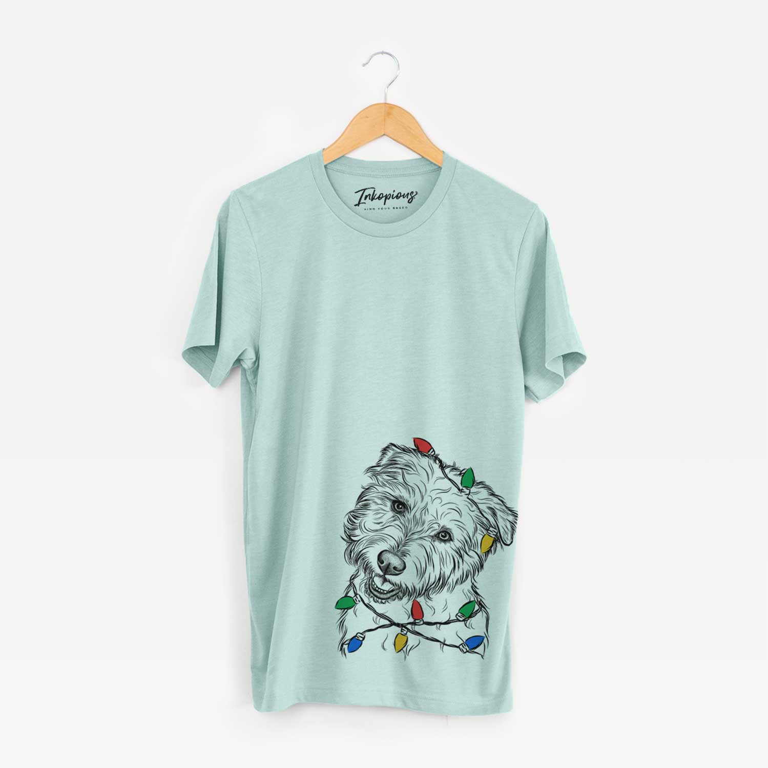 Hand-drawn sketch of Duffy the Glen of Imaal Terrier wrapped in Christmas lights on a Heather Sage Unisex crewneck