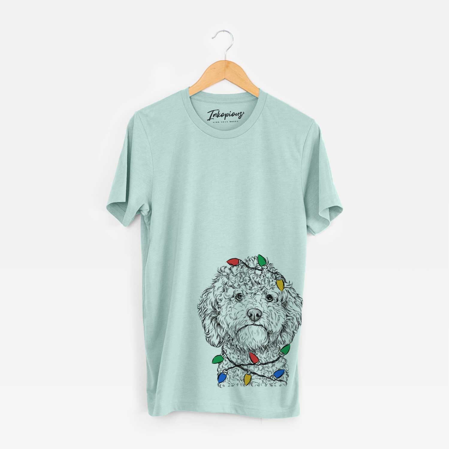Hand-drawn sketch of Edgar the Shihpoo wrapped in Christmas lights on a Heather Sage Unisex crewneck
