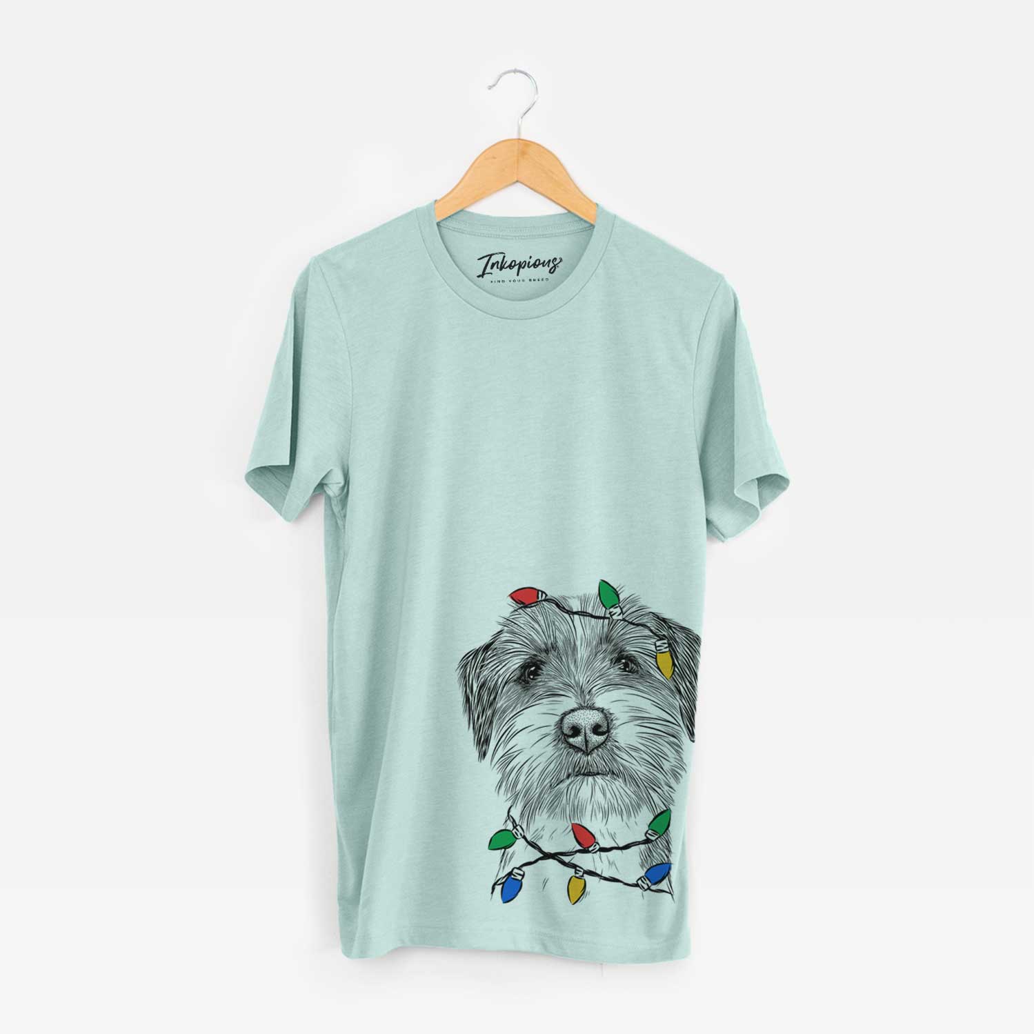 Hand-drawn sketch of Feis the Parson Russell Terrier wrapped in Christmas lights on a Heather Sage Unisex crewneck