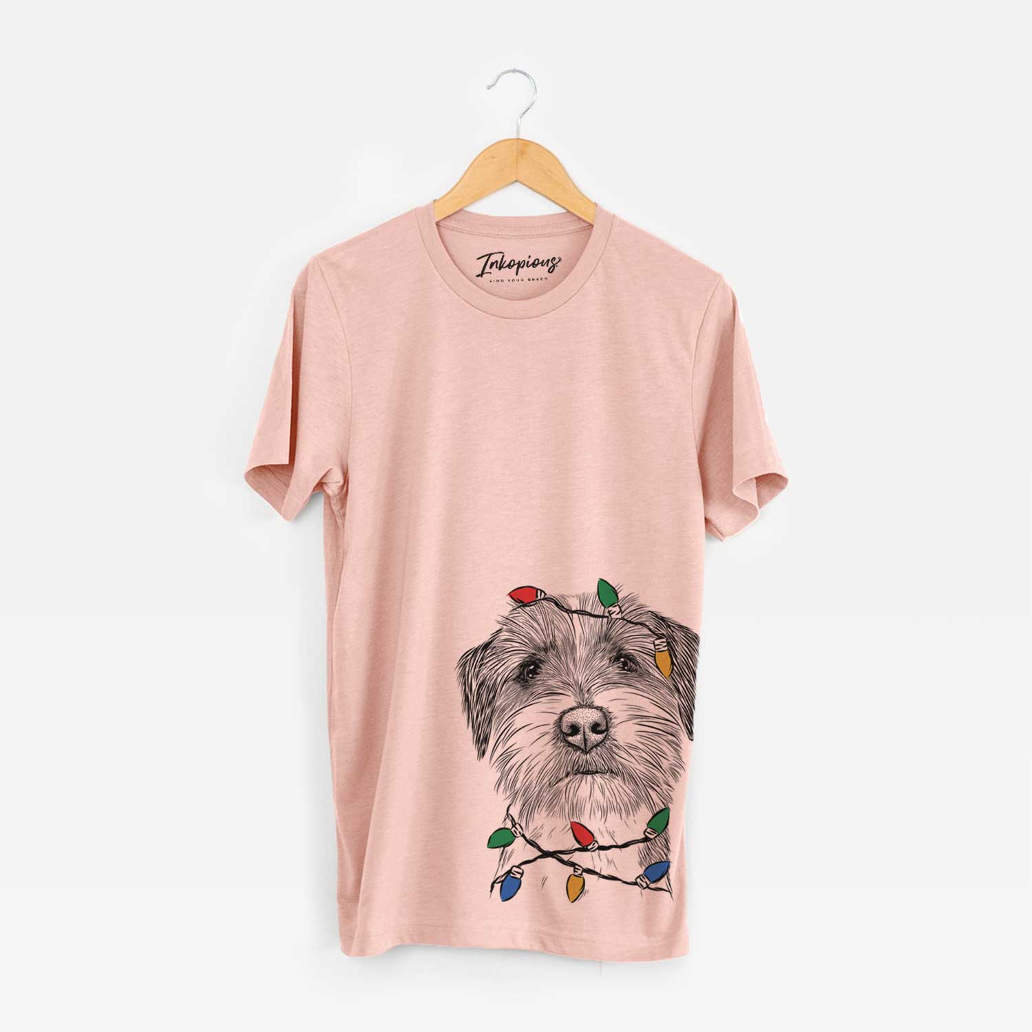 Hand-drawn sketch of Feis the Parson Russell Terrier wrapped in Christmas lights on a Peach Unisex crewneck