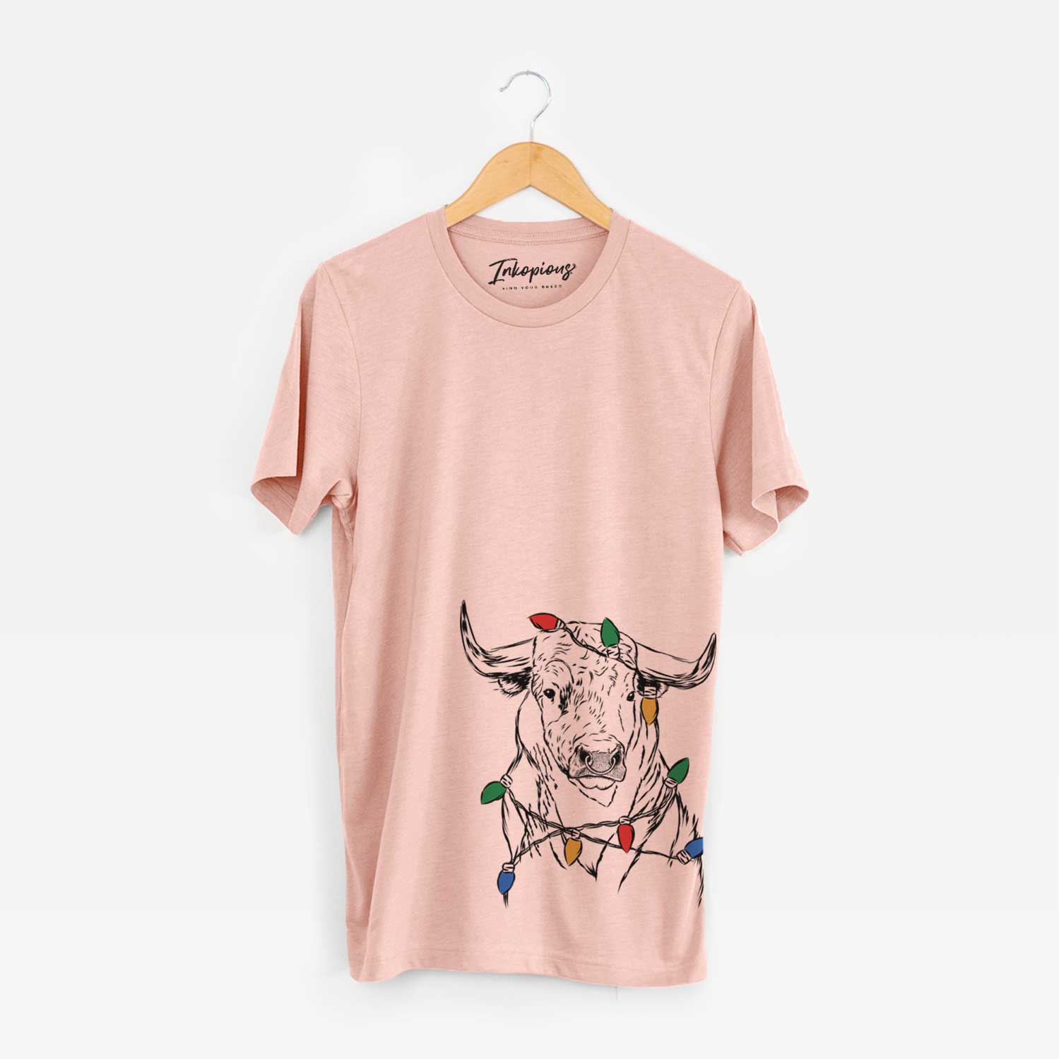 Hand-drawn sketch of Ferdinand the Bull wrapped in Christmas lights on a Peach Unisex crewneck