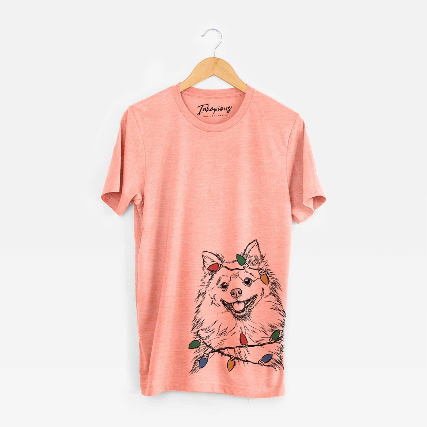 Hand-drawn sketch of Fibi the Spitz wrapped in Christmas lights on a Sunset Unisex crewneck