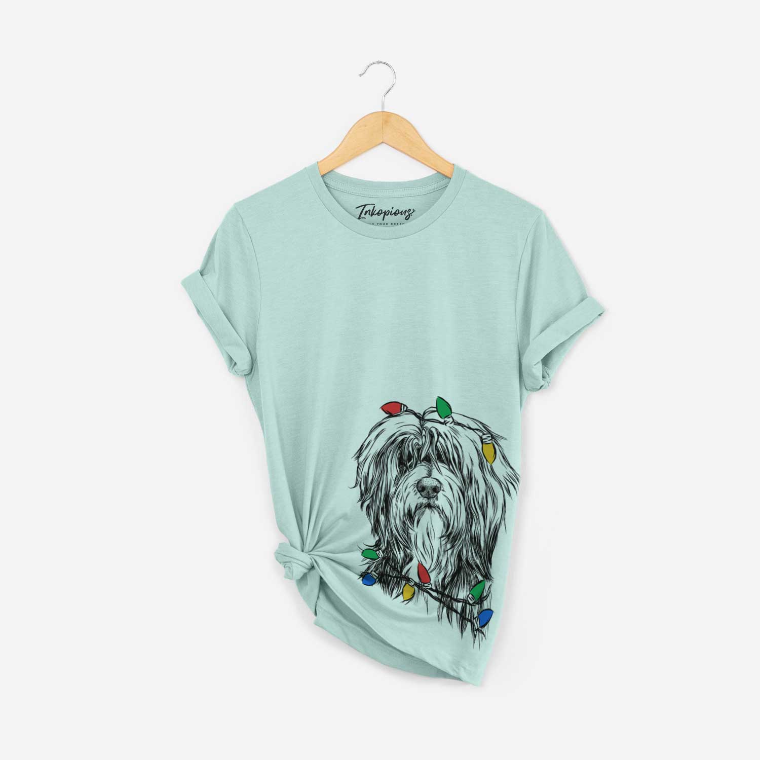 Hand-drawn sketch of Fiji the Polish Lowland Sheepdog wrapped in Christmas lights on a Heather Sage Unisex crewneck