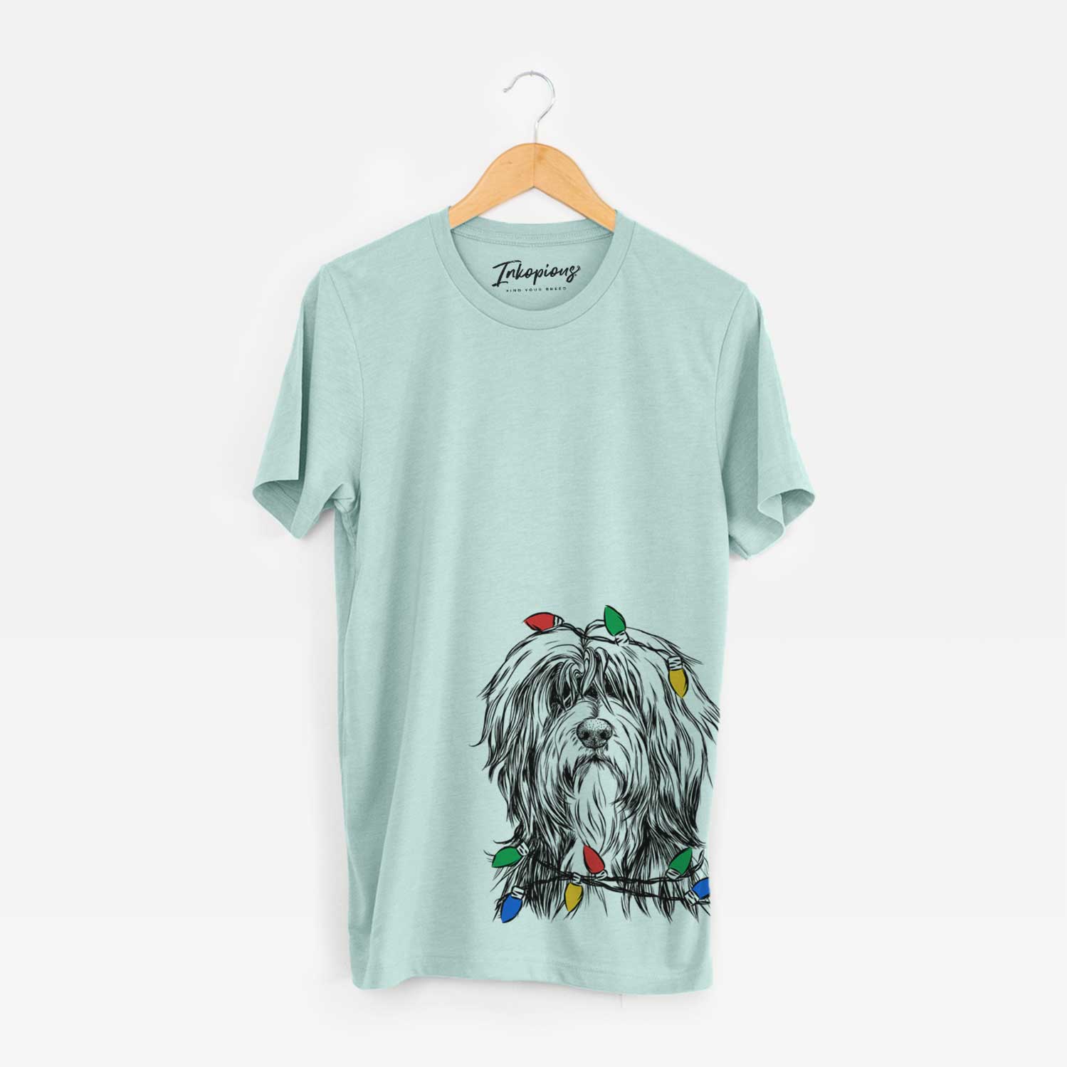 Hand-drawn sketch of Fiji the Polish Lowland Sheepdog wrapped in Christmas lights on a Heather Sage Unisex crewneck