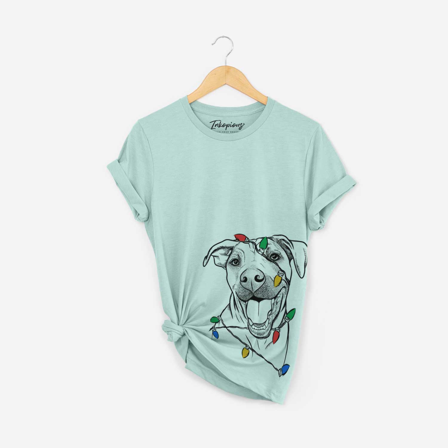 Hand-drawn sketch of Finn the Hound Mix wrapped in Christmas lights on a Heather Sage Unisex crewneck