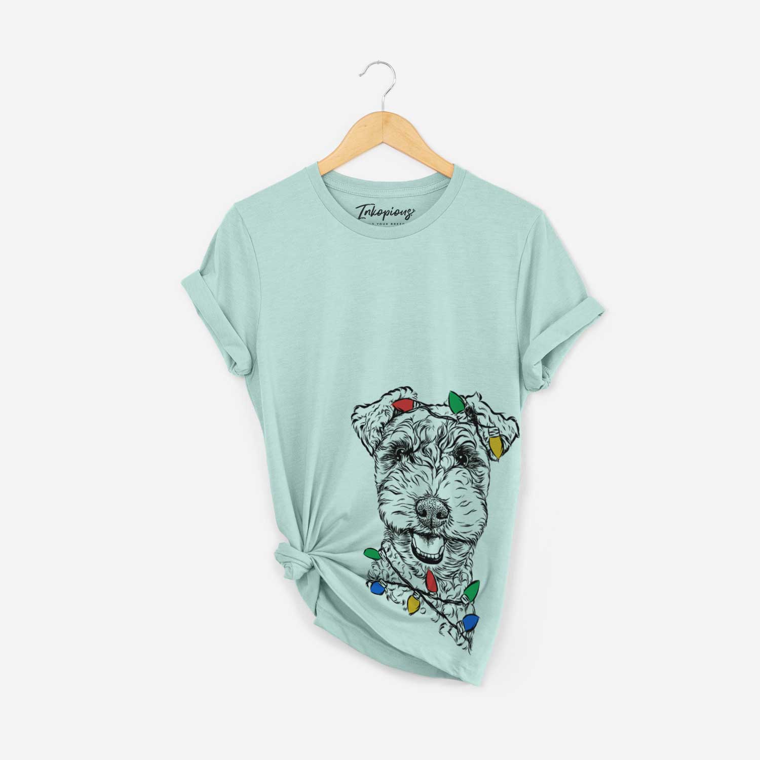 Hand-drawn sketch of Fintan the Irish Troodle wrapped in Christmas lights on a Heather Sage Unisex crewneck