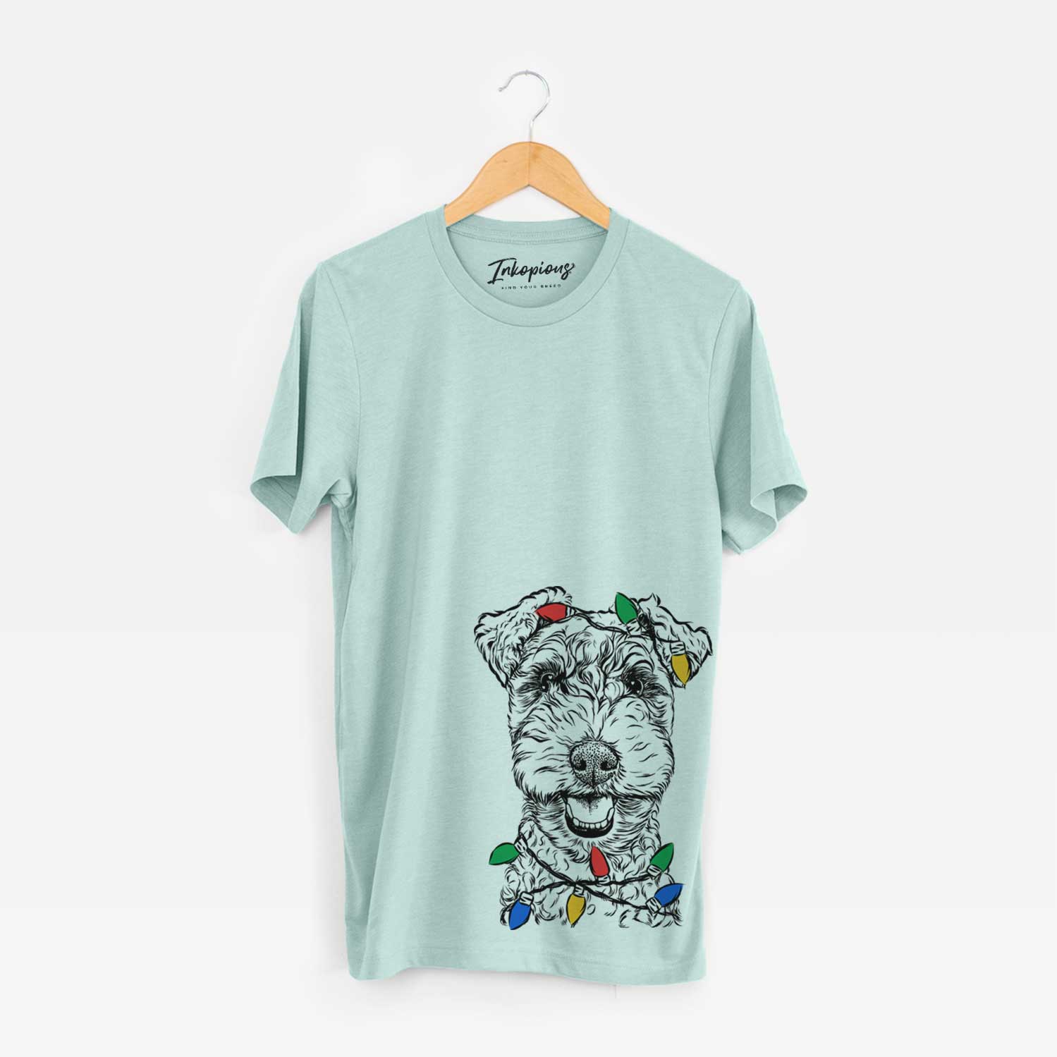 Hand-drawn sketch of Fintan the Irish Troodle wrapped in Christmas lights on a Heather Sage Unisex crewneck