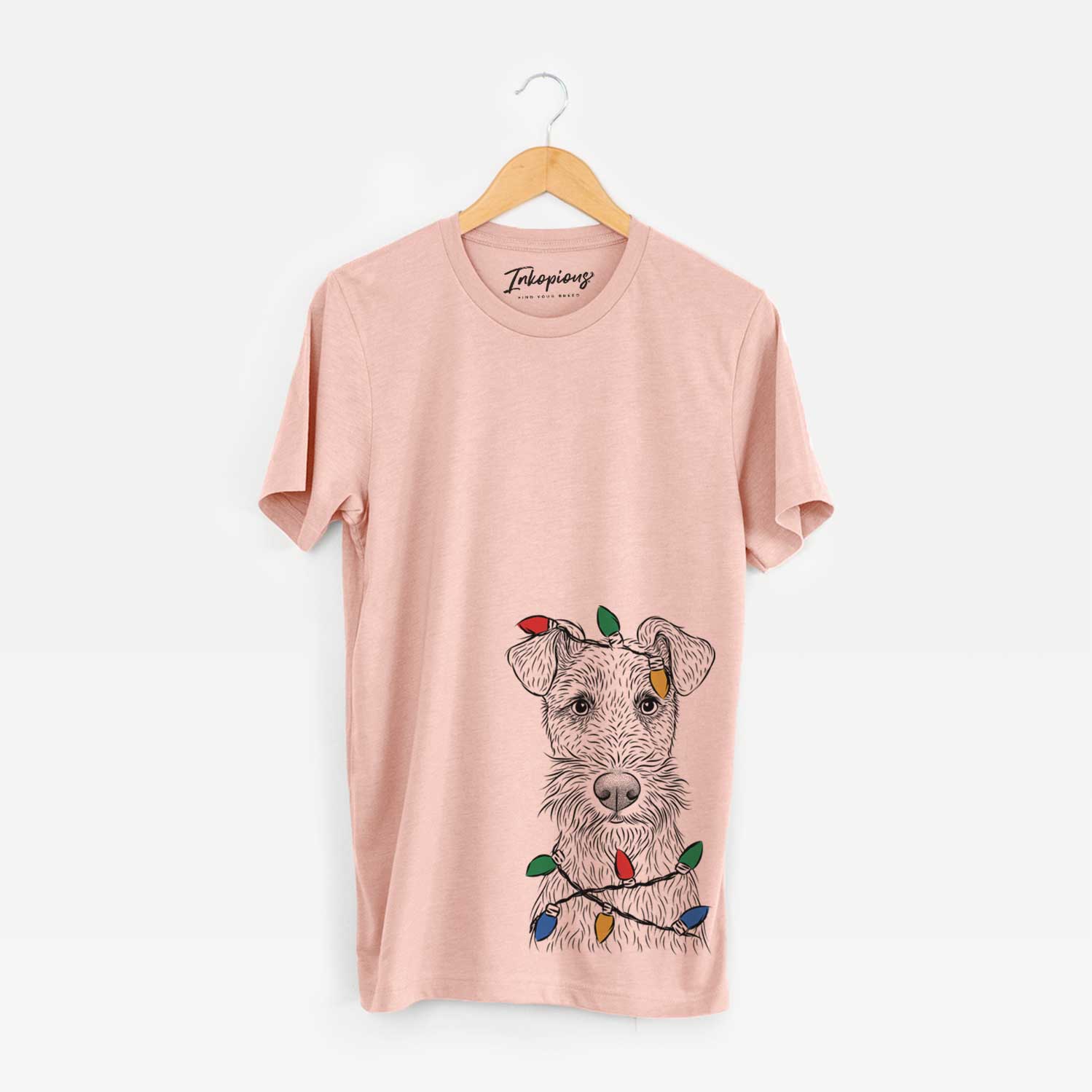 Hand-drawn sketch of Fitz the Wire Fox Terrier wrapped in Christmas lights on a Peach Unisex crewneck