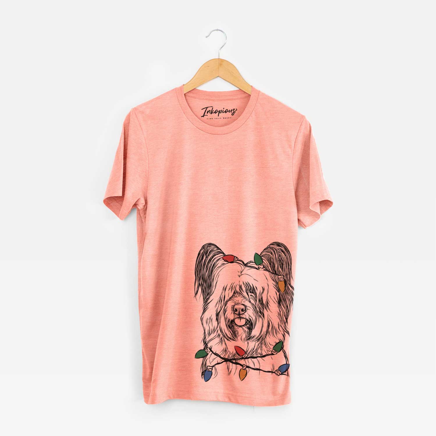 Hand-drawn sketch of Gideon the Skye Terrier wrapped in Christmas lights on a Sunset Unisex crewneck