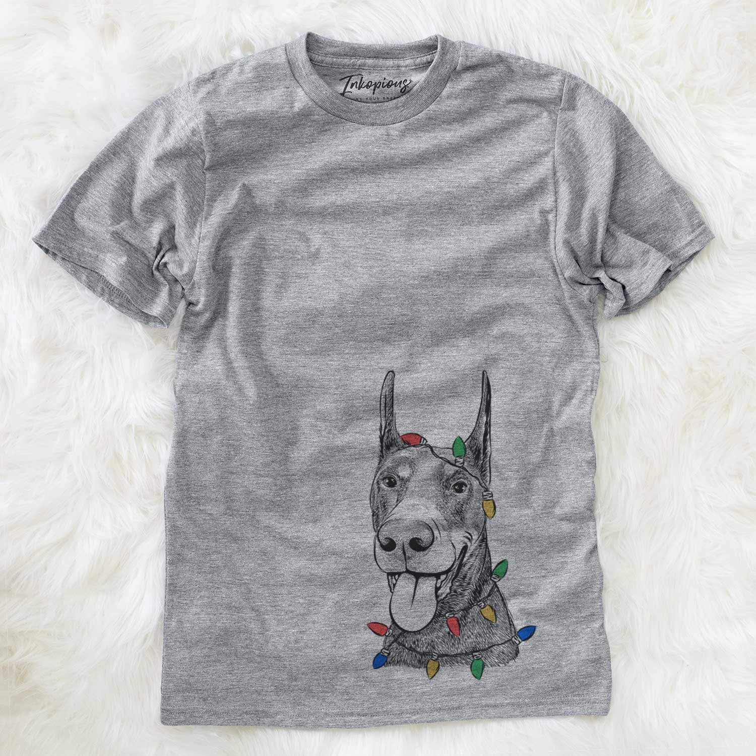 Hand-drawn sketch of Happy Sunny the Doberman Pinscher wrapped in Christmas lights on a Grey Unisex crewneck