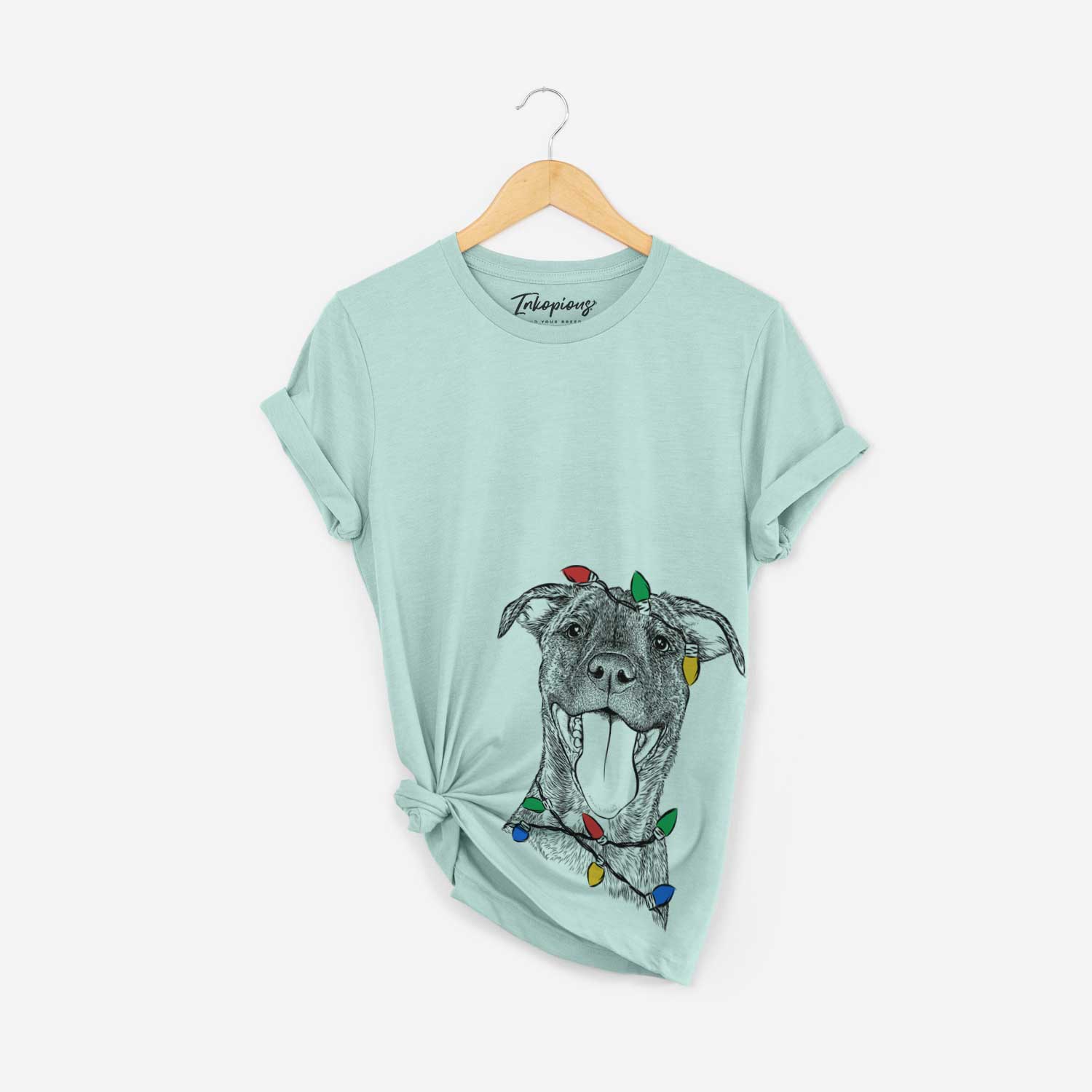 Hand-drawn sketch of Harley the Pitbull Mix wrapped in Christmas lights on a Heather Sage Unisex crewneck